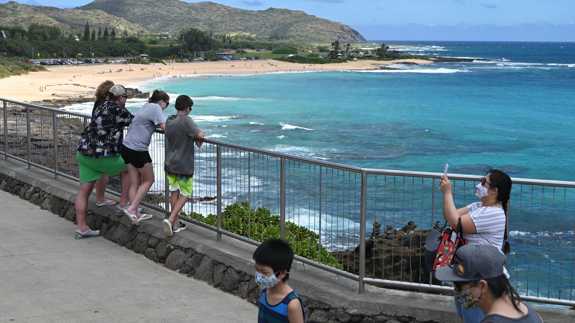 People wearing masks at a Hawaii beach