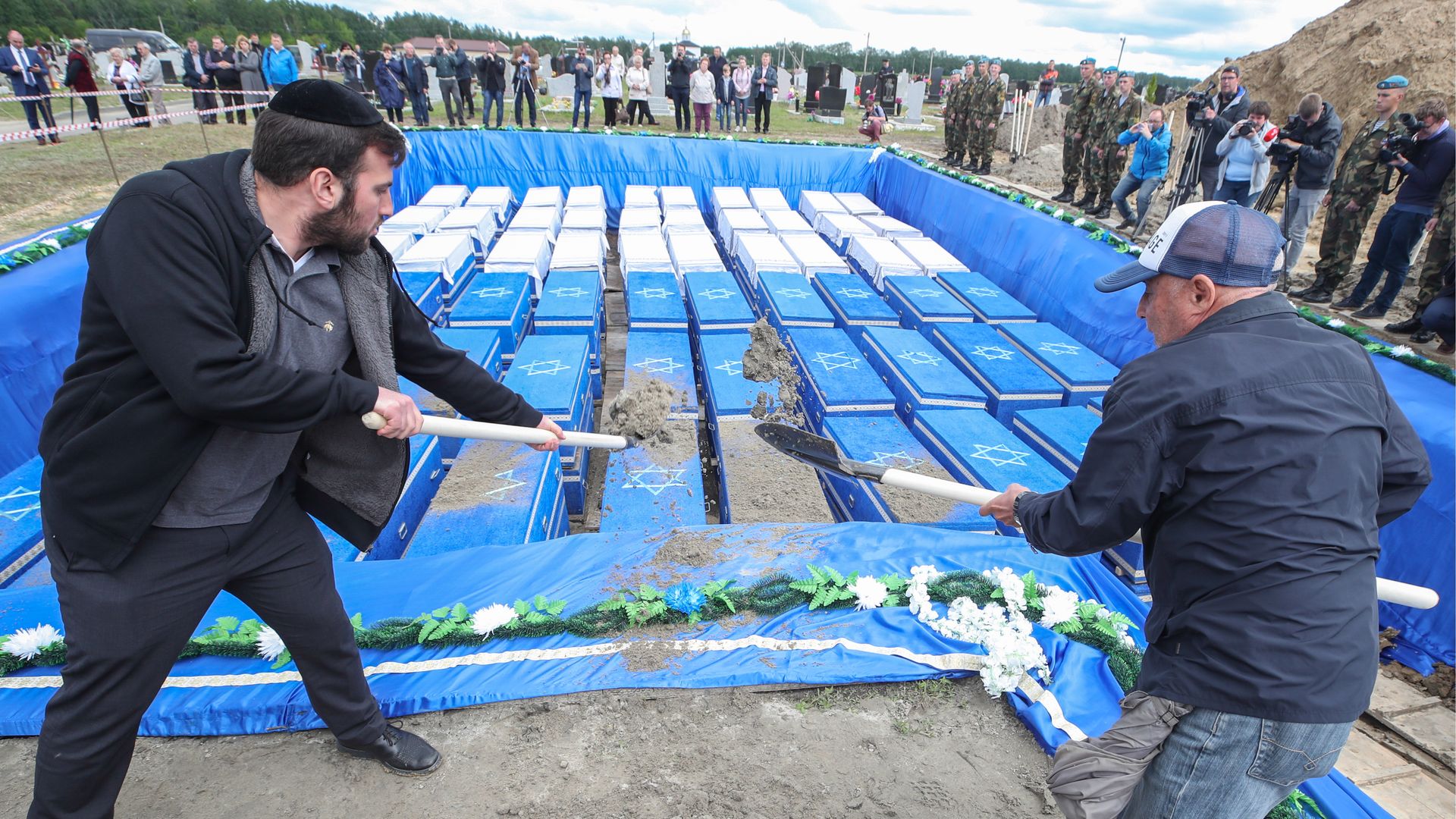 Members of Jewish communities rebury the remains of Jews killed by the Nazis, at the Severnoye cemetery.