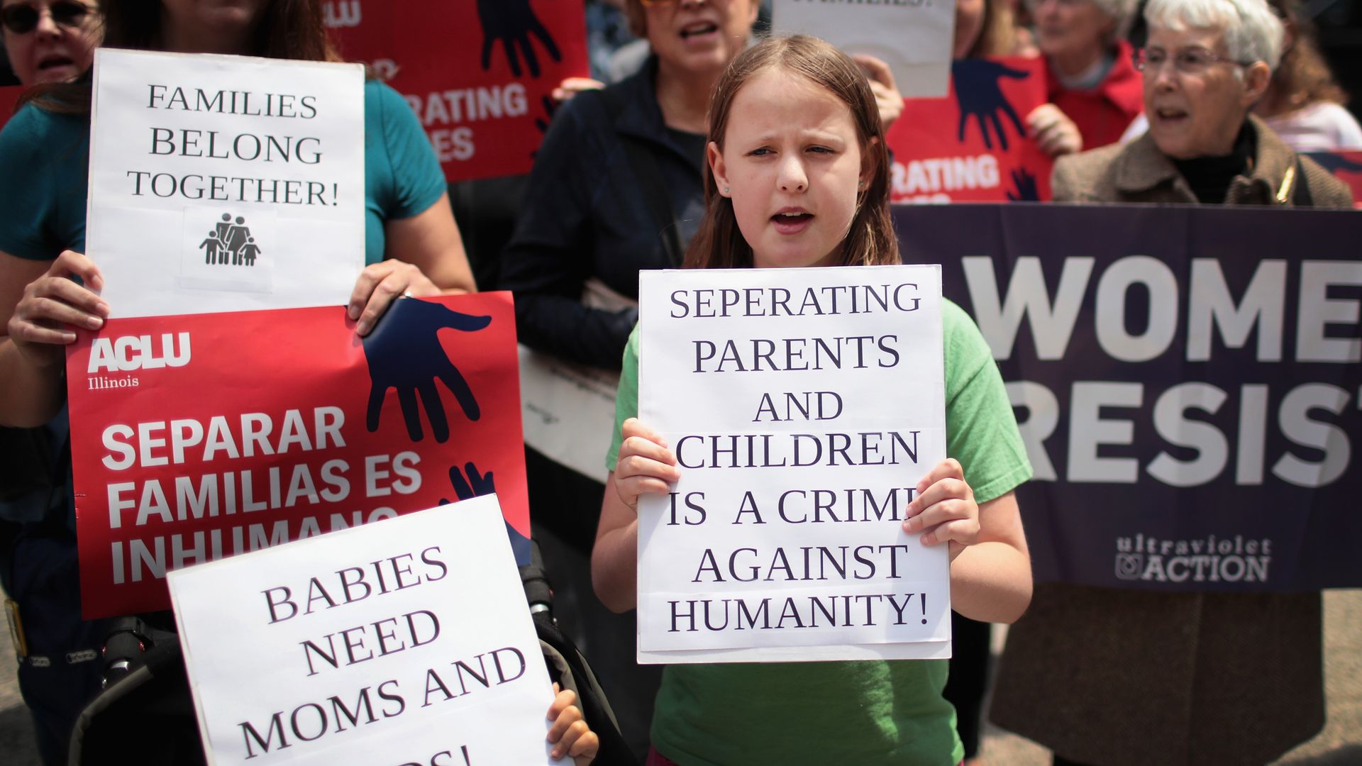 A young child in a crowd protesting the Trump administration's family separation policies at the border