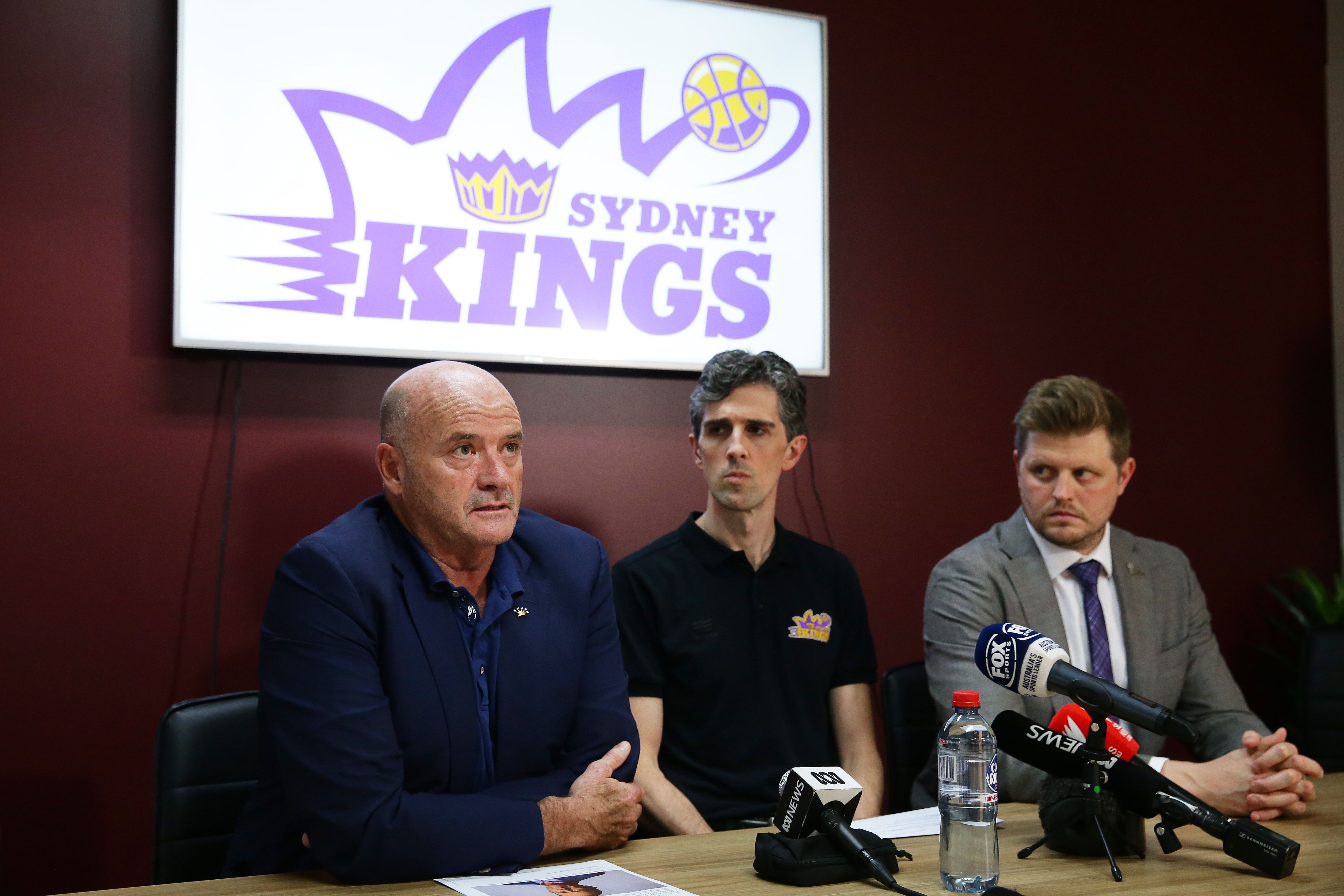 Three men at a podium