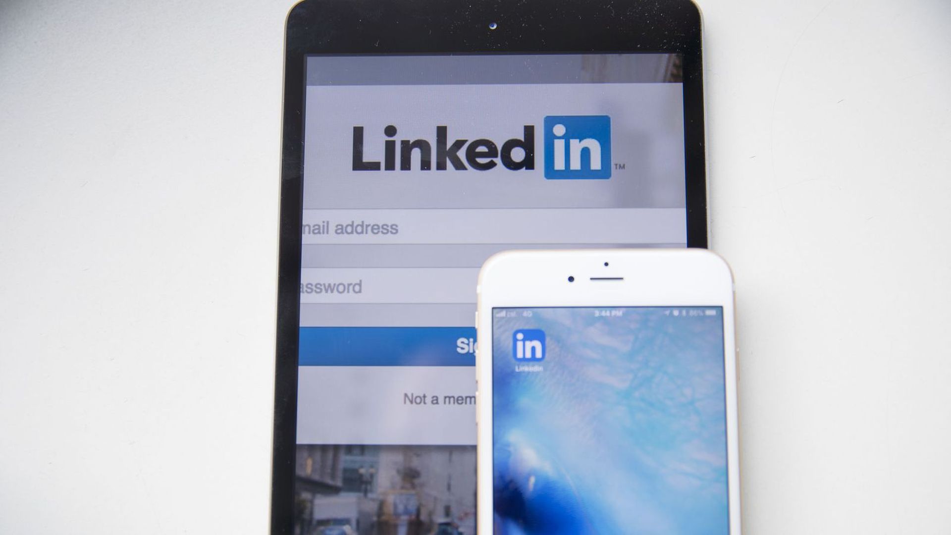 An image of the LinkedIn logo on a phone and a LinkedIn login screen on another device.