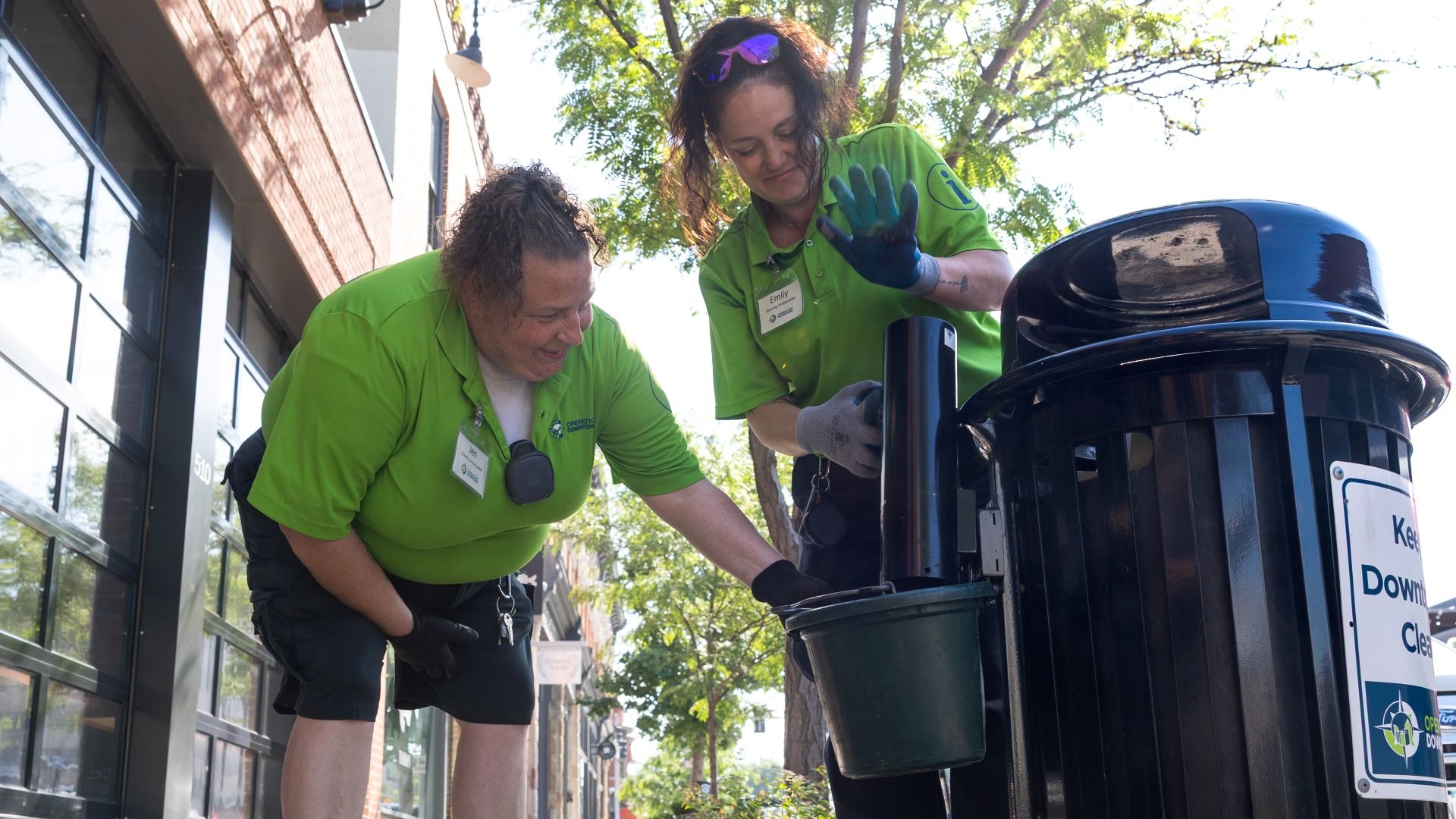 A photo of people collecting cigarette butts.