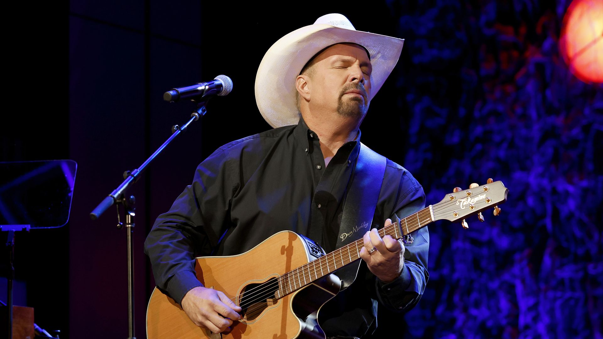 Photo shows Garth Brooks performing on stage