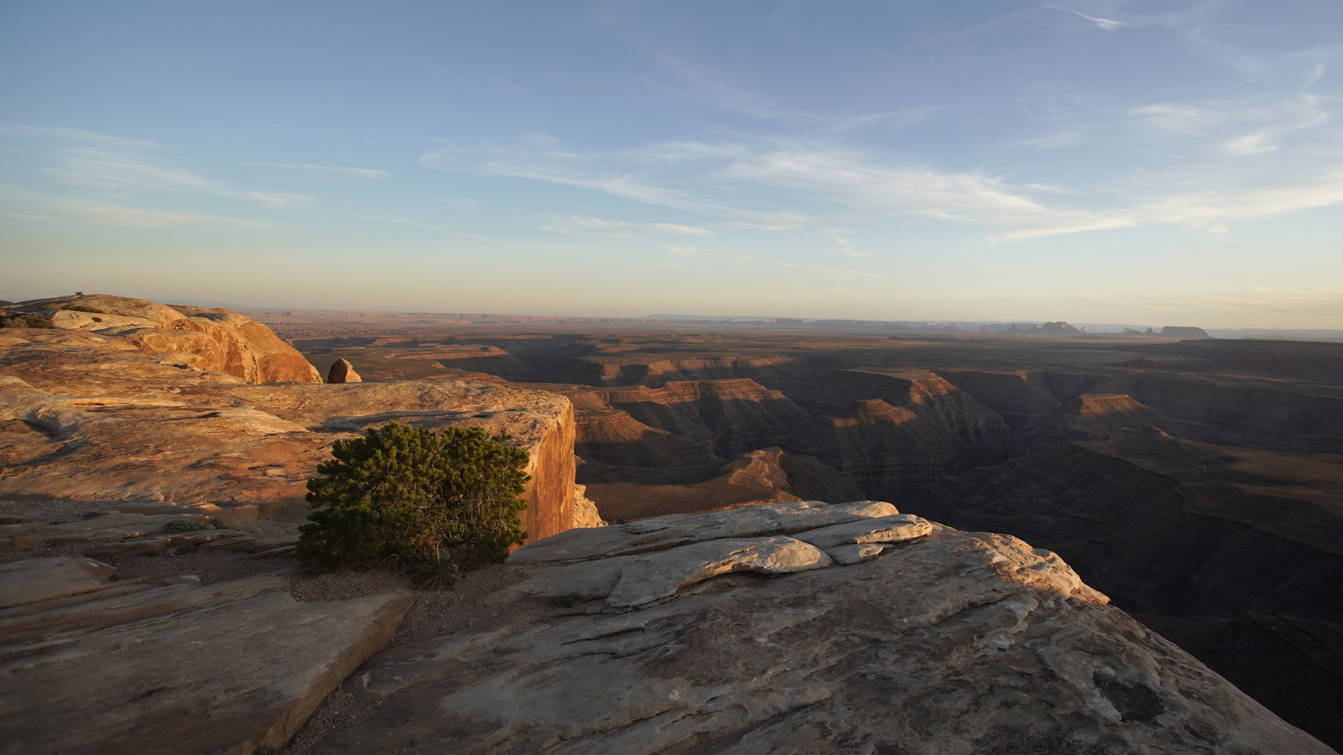 The sun sets over Monument Valley in the distance as seen from the Bears Ears National Monument.