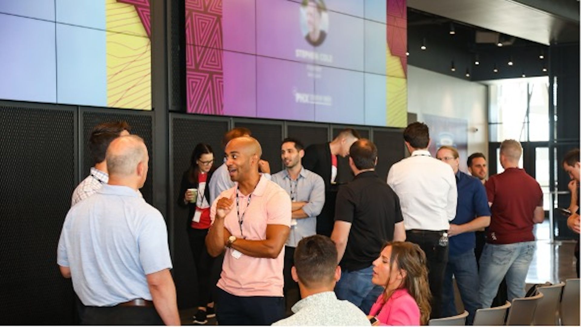 People in business casual networking at an event.