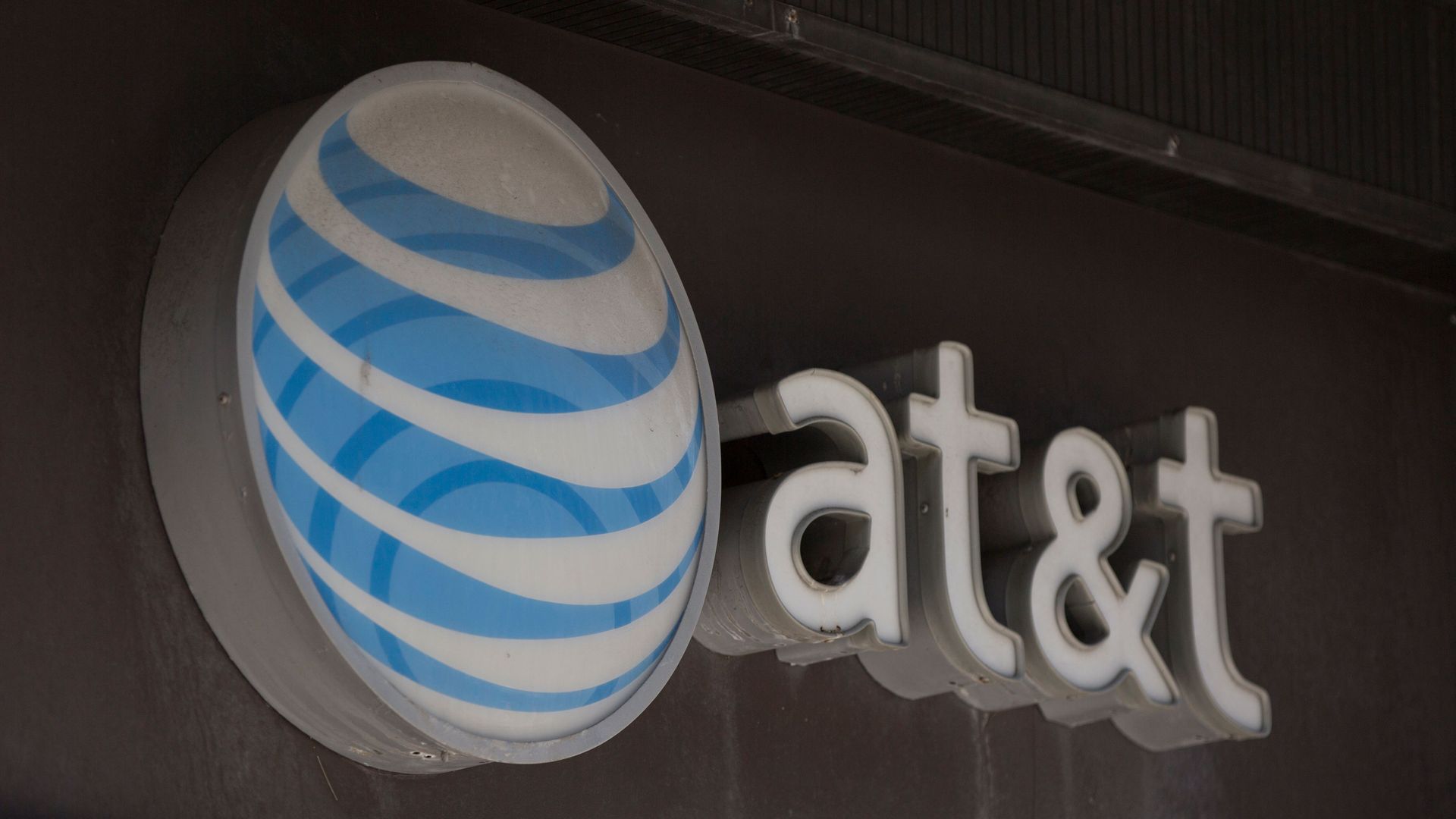 A photo of AT&T's logo and next to the company's name.