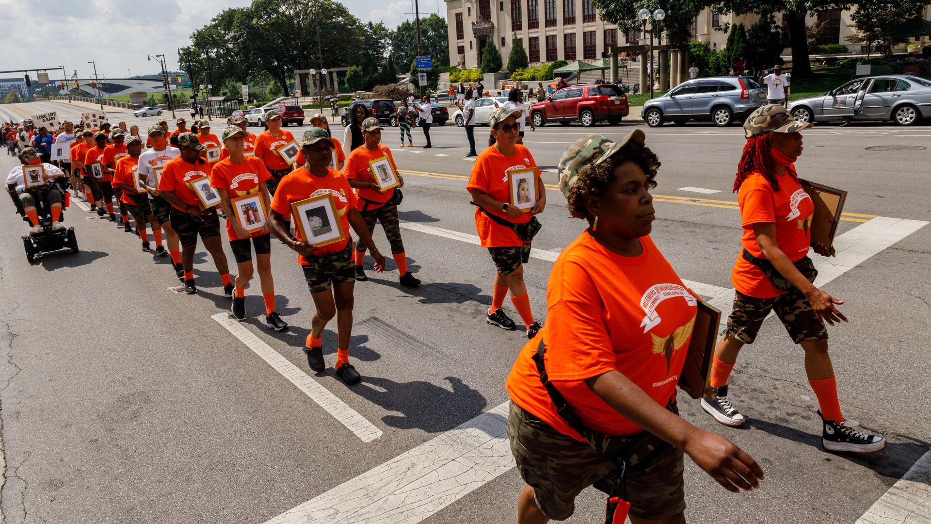 Members of Mothers of Murdered Columbus Children march down the street in protest of violent crime.