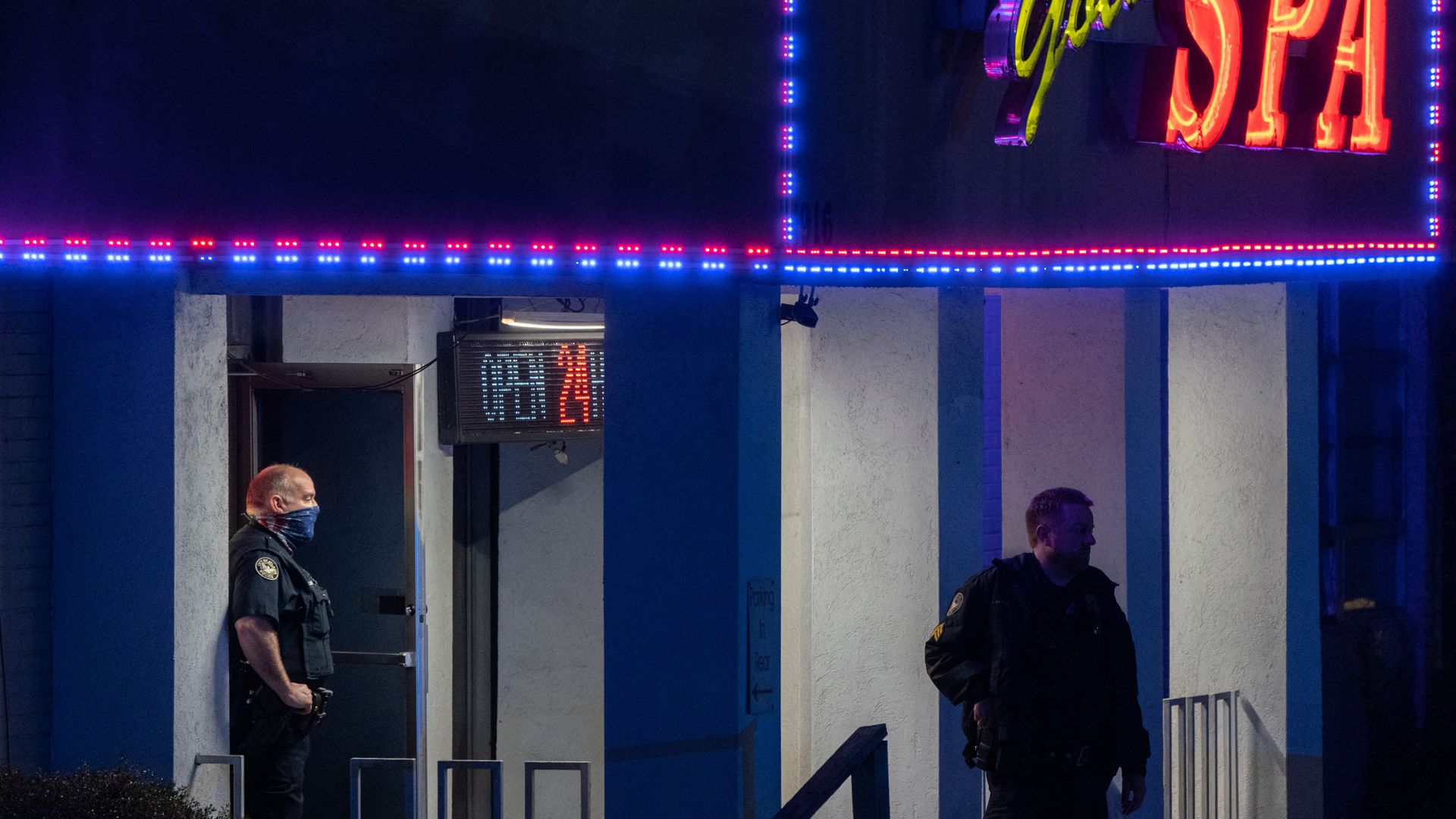 Two men stand under a sign that says Golden Spa