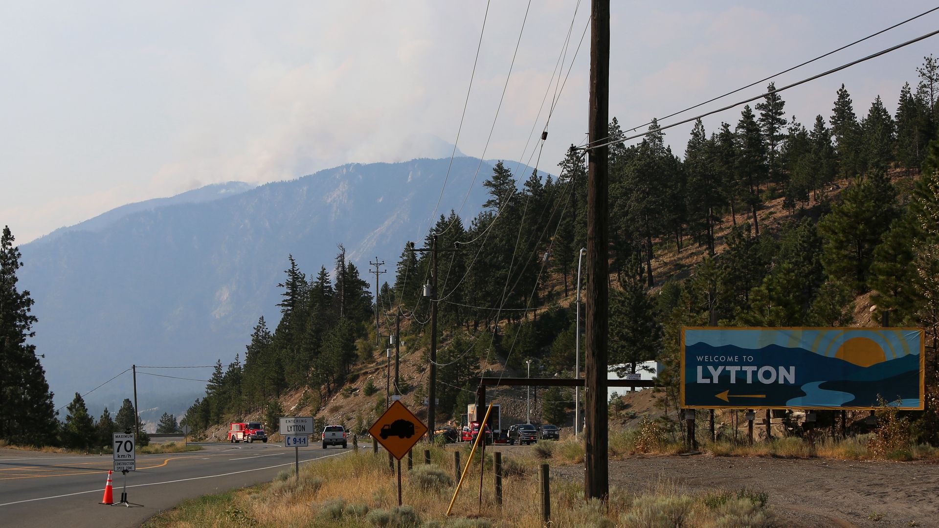 Smoke rises over the mountains in Lytton, as firefighters still battle the fires in British Columbia, July 6