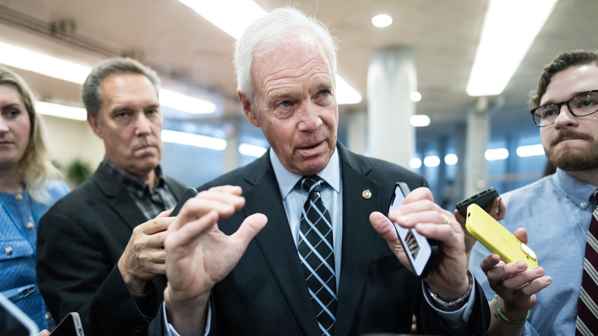 Ron Johnson gestures as he speaks to reporters on Capitol Hill.