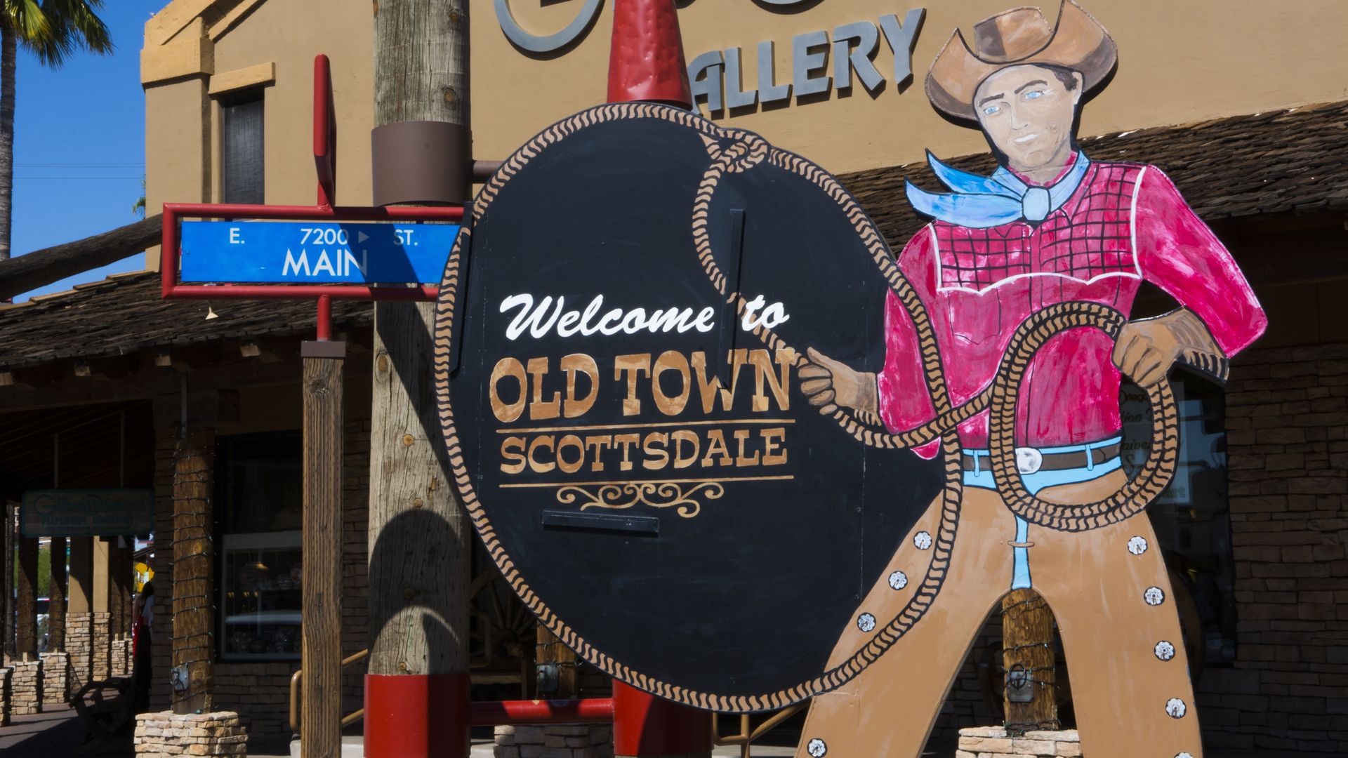 "Welcome to Old Scottsdale" sign featuring a cowboy with a lasso