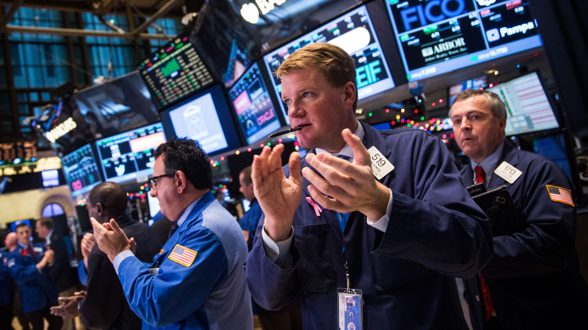 Traders applaud at the New York Stock Exchange.