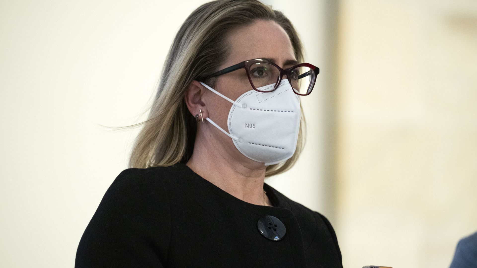 Sen. Kyrsten Sinema, D-Ariz., arrives for a Senate Democrats luncheon with President Joe Biden