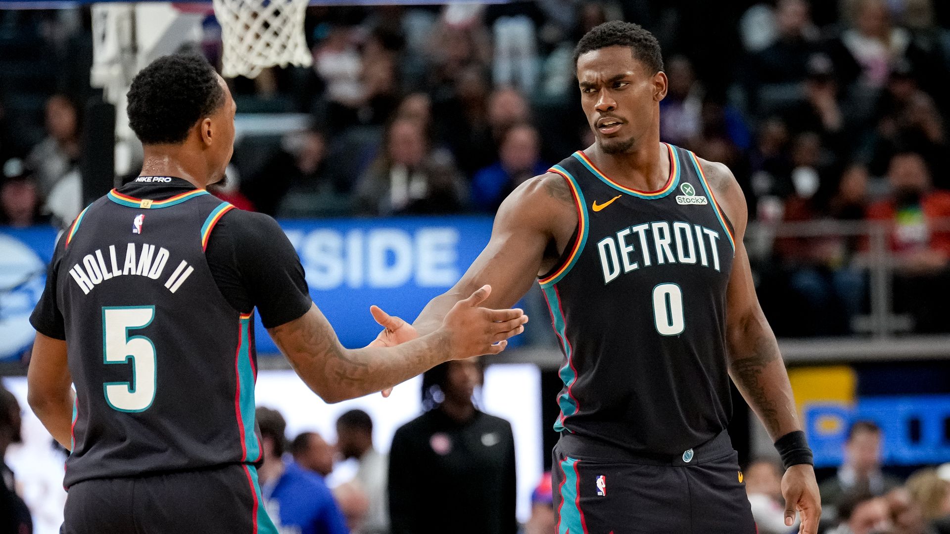 Teammates Ronald Holland II and Jalen Duren slap hands against New Orleans. 
