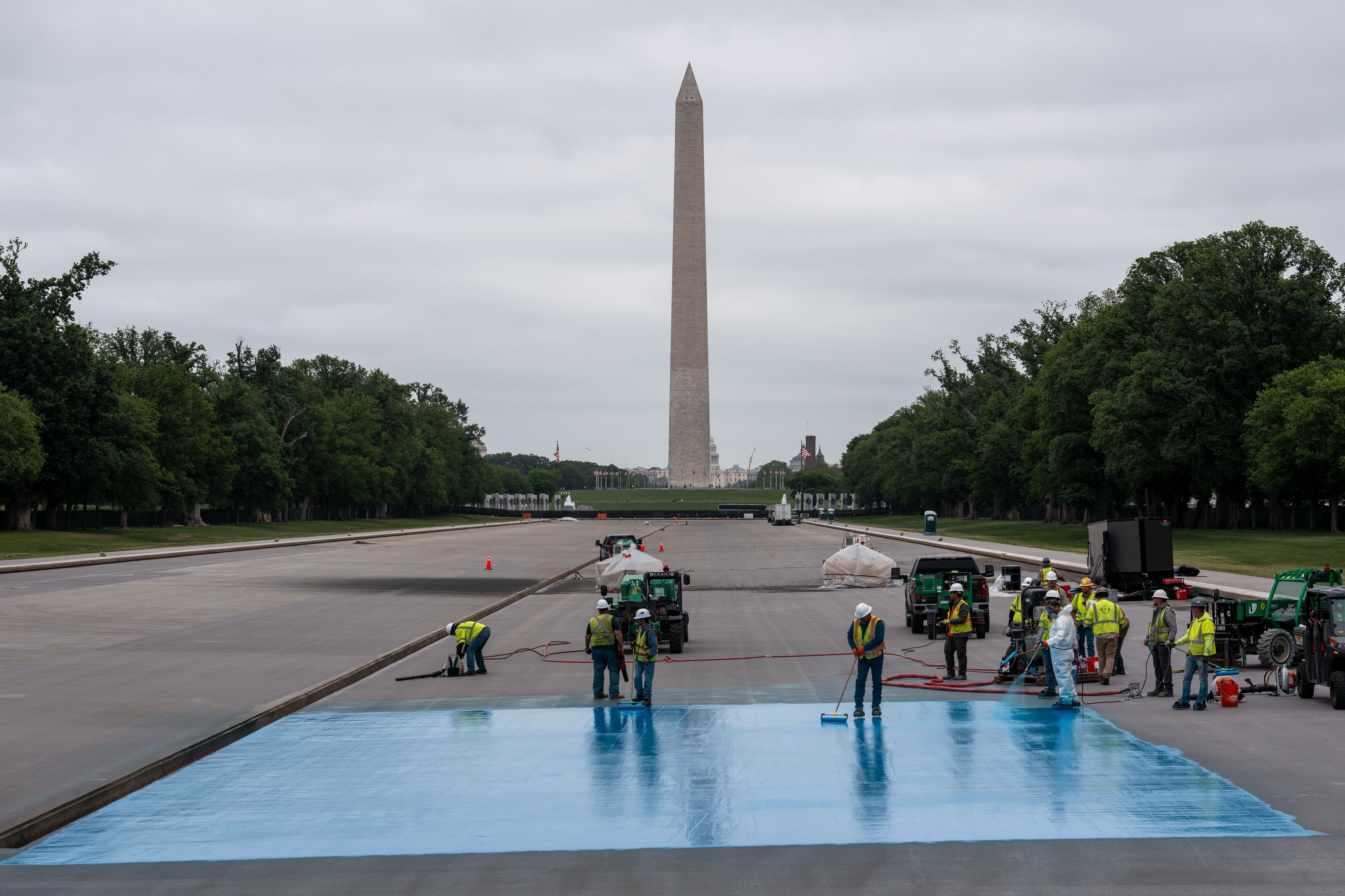 Crews spray a new blue coating on the Lincoln Memorial Reflecting Pool