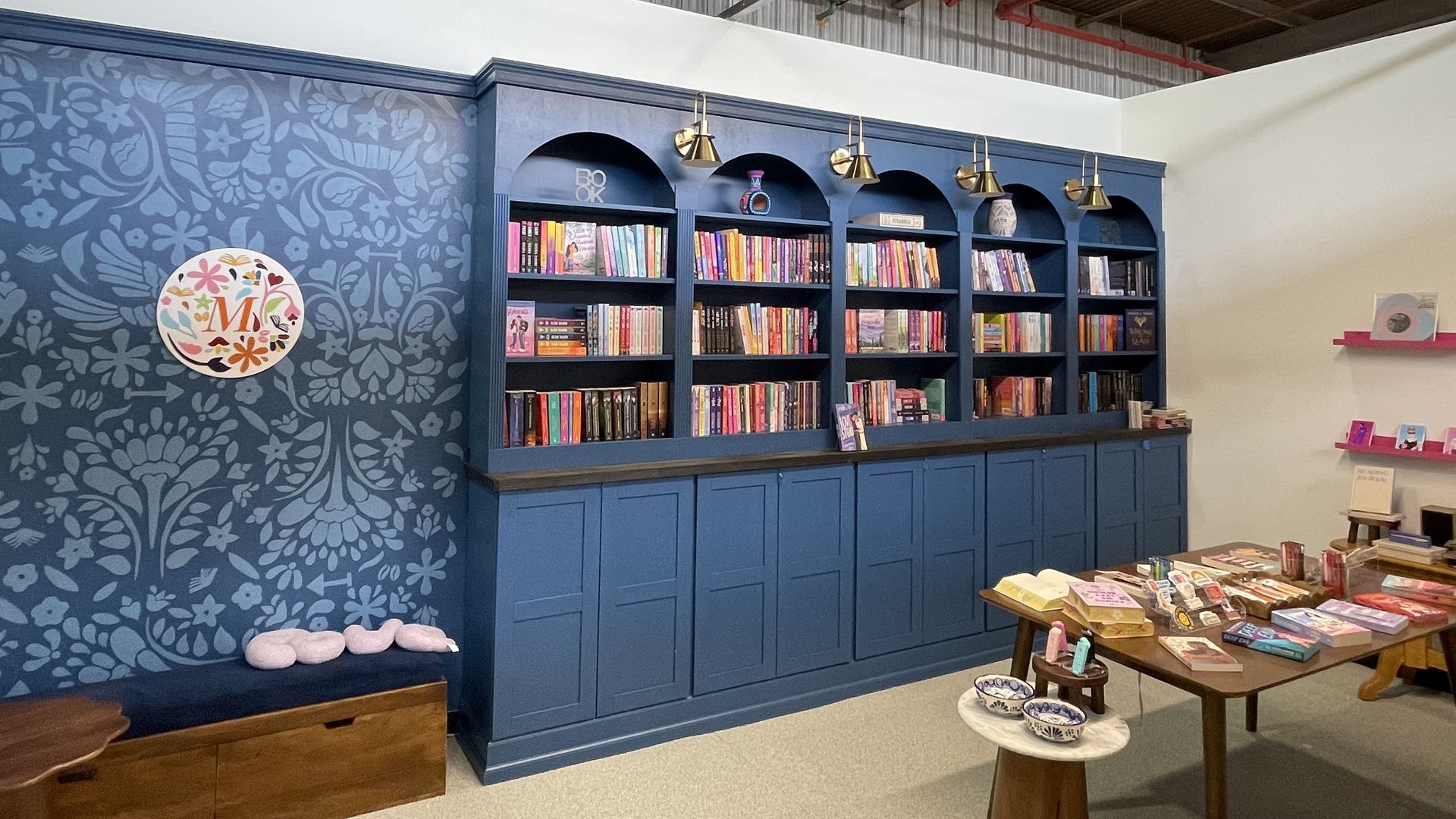 Photo of a blue bookshelf with many books.