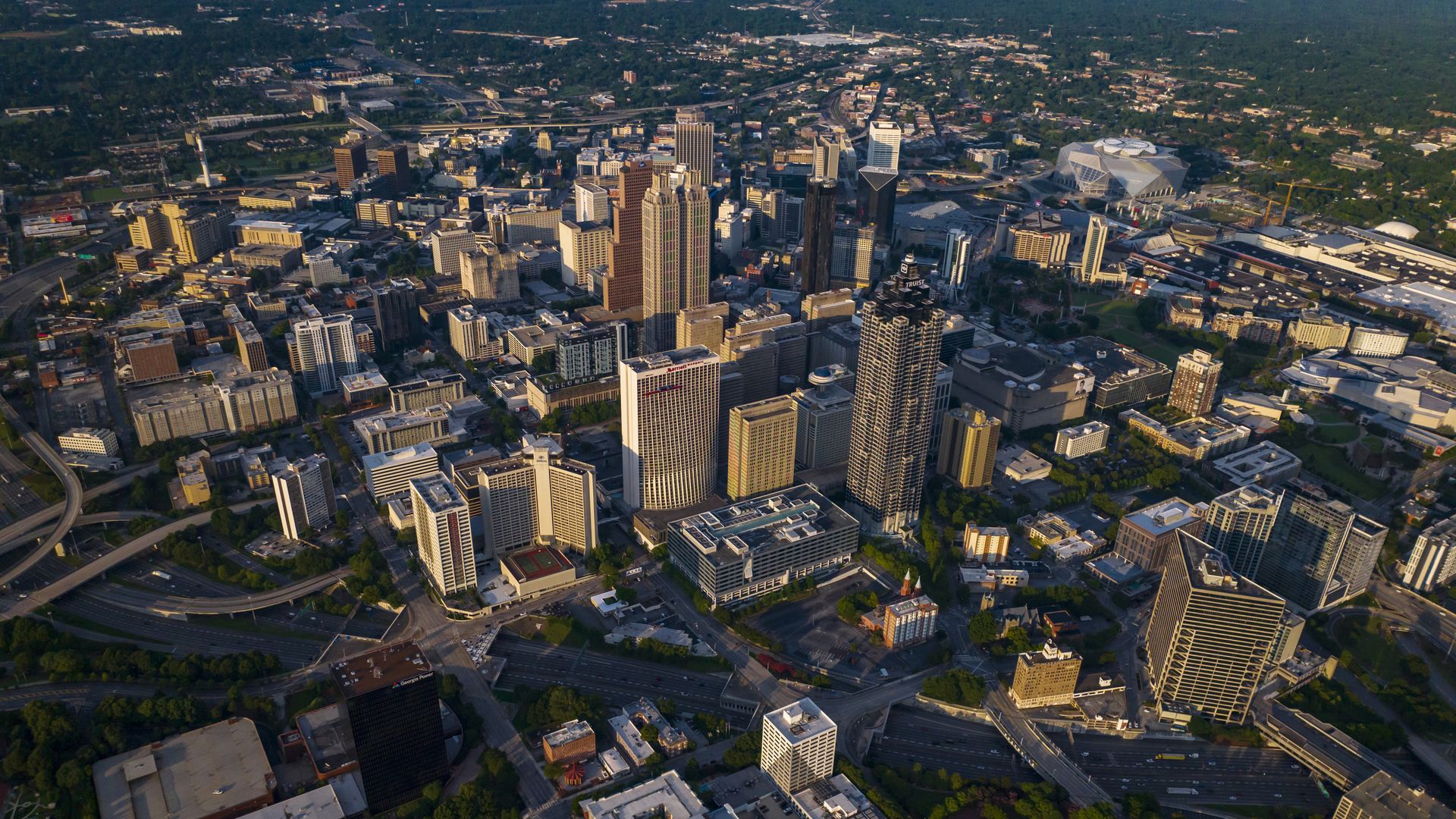 An aerial photograph of Downtown Atlanta bordered by a tree canopy