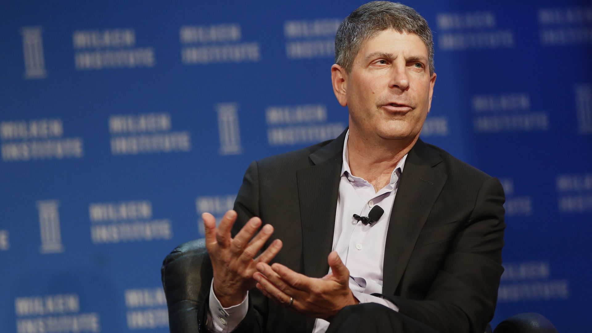 Photo of Jeff Shell of NBCUniversal in a dark suit, light shirt with his hands at his lap