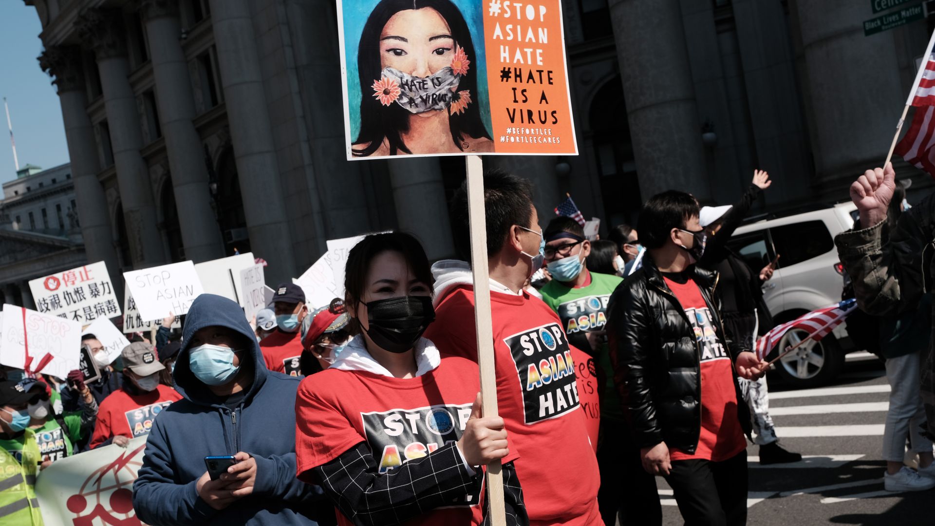 Photo of a crowd of protesters holding signs related to Stop Asian Hate