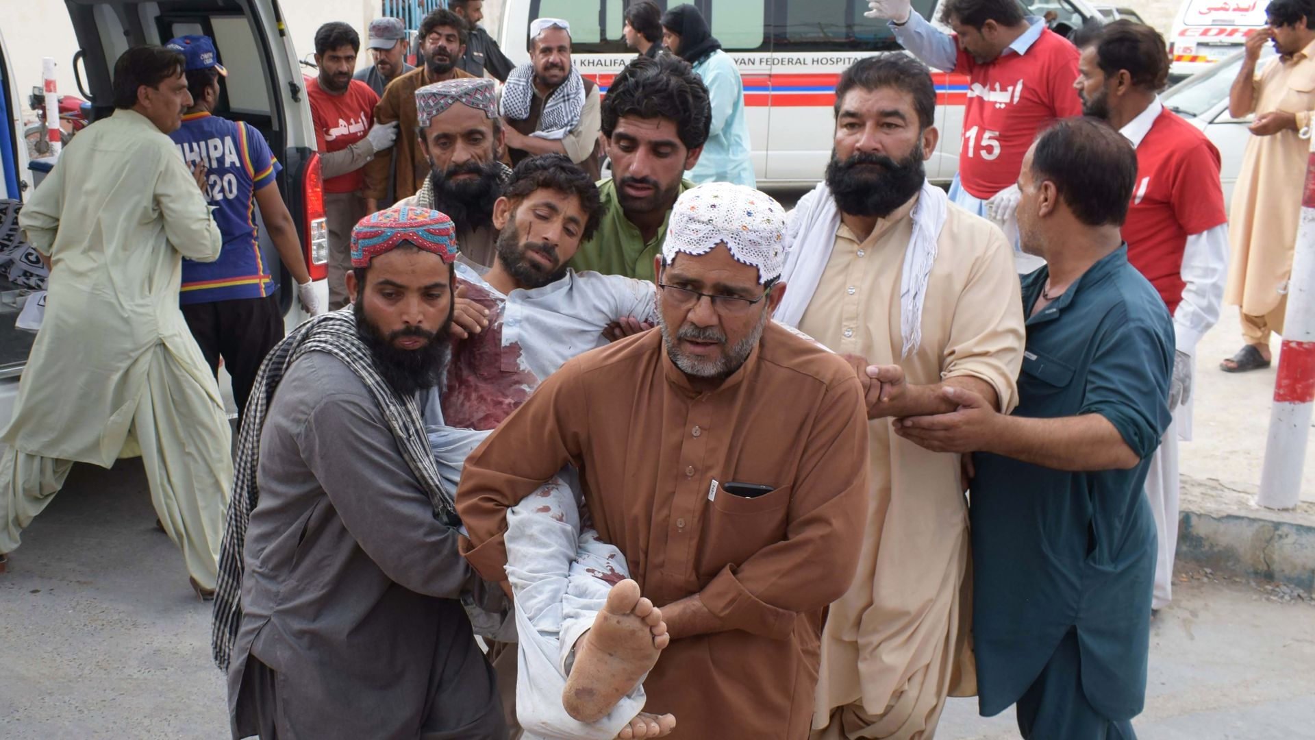 An injured Pakistani man is carried to a hospital