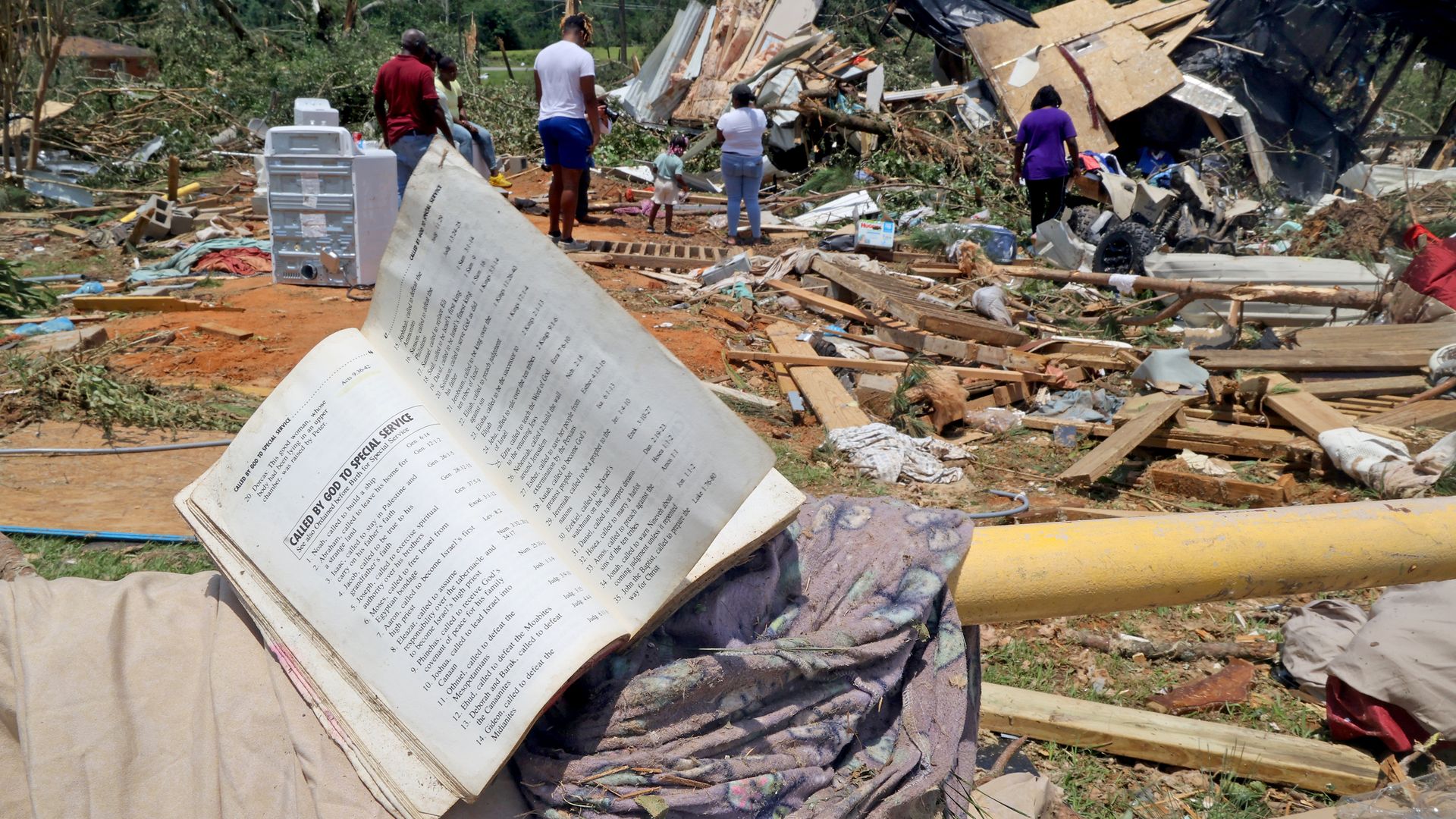 The wind blows the pages of a salvaged prayer book in a tornado-damaged neighborhood on June 19, 2023 in Louin, Mississippi. There were multiple confirmed tornadoes overnight in Mississippi that left at least one person killed and 25 injured during the storms. 