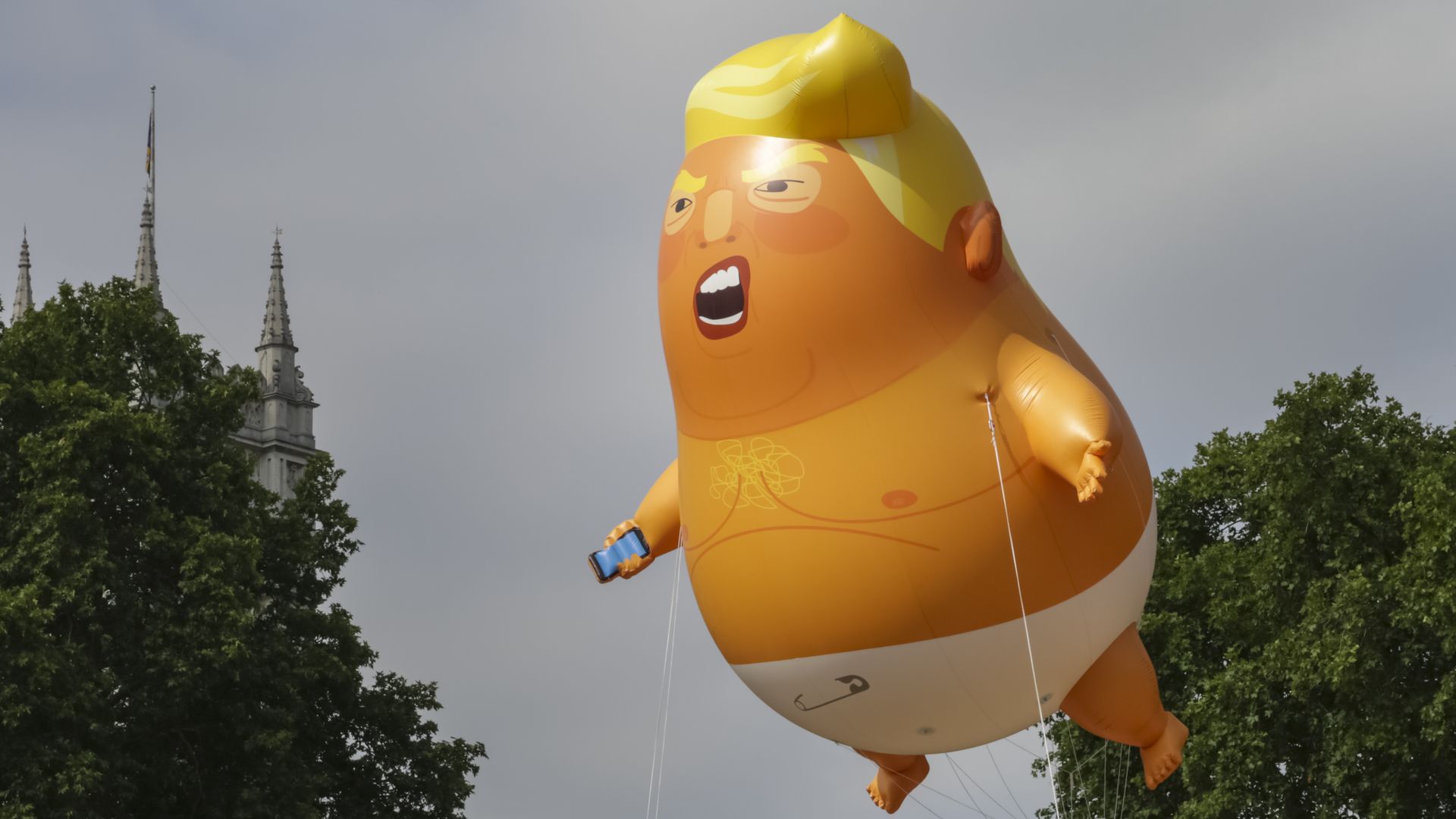 A Trump baby blimp flying in the sky.