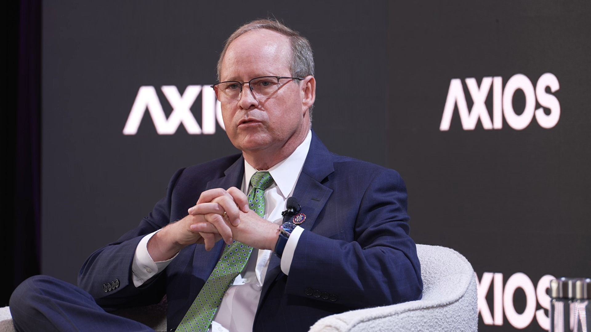 Rep. Greg Murphy, wearing a blue suit and sitting in a gray chair in front of a gray "Axios" backdrop.