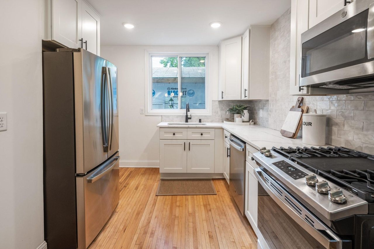 modern kitchen with stainless appliances and white cabinets