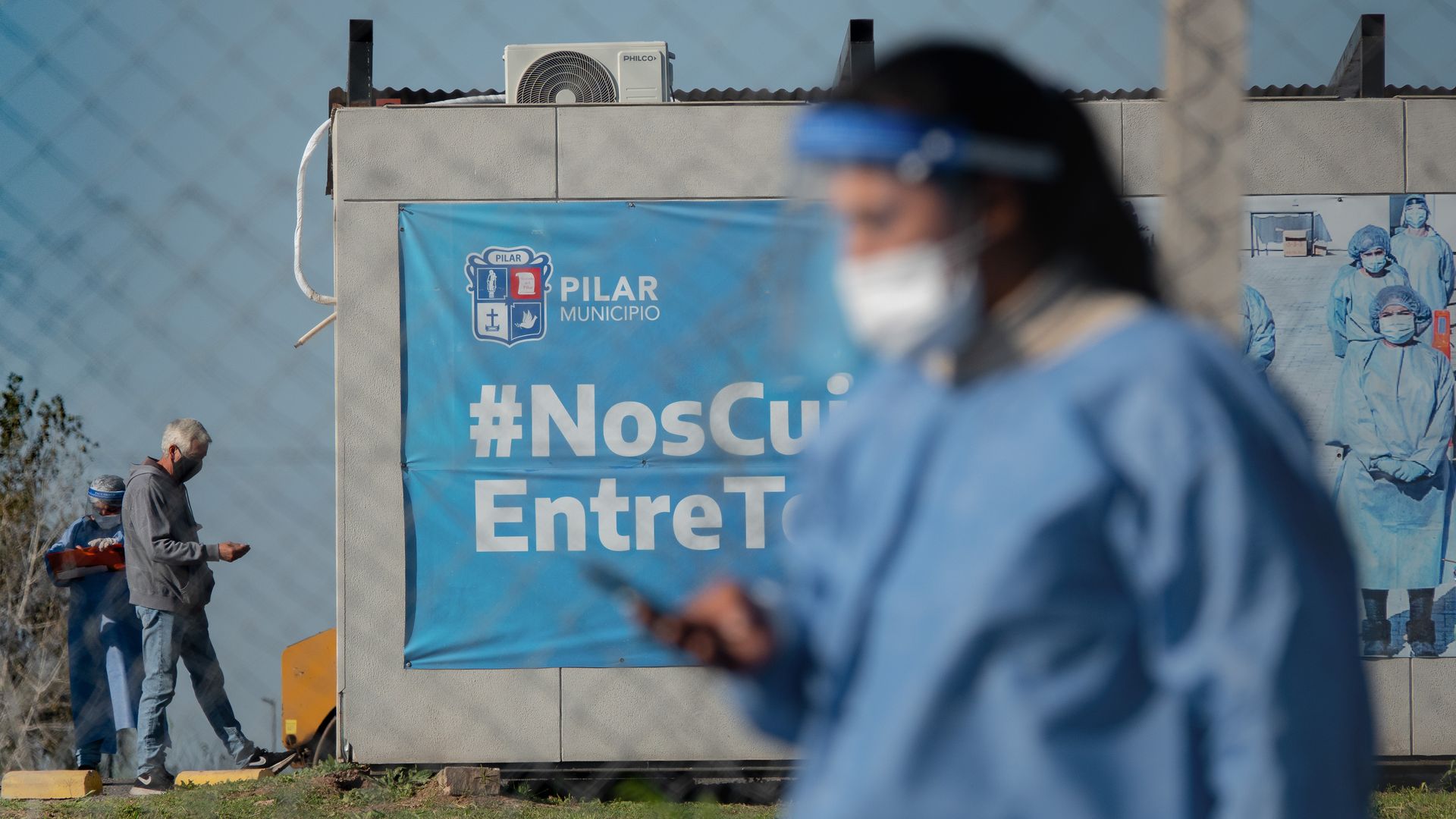 27 April 2021, Argentina, Buenos Aires: A health worker walks past a testing center. 
