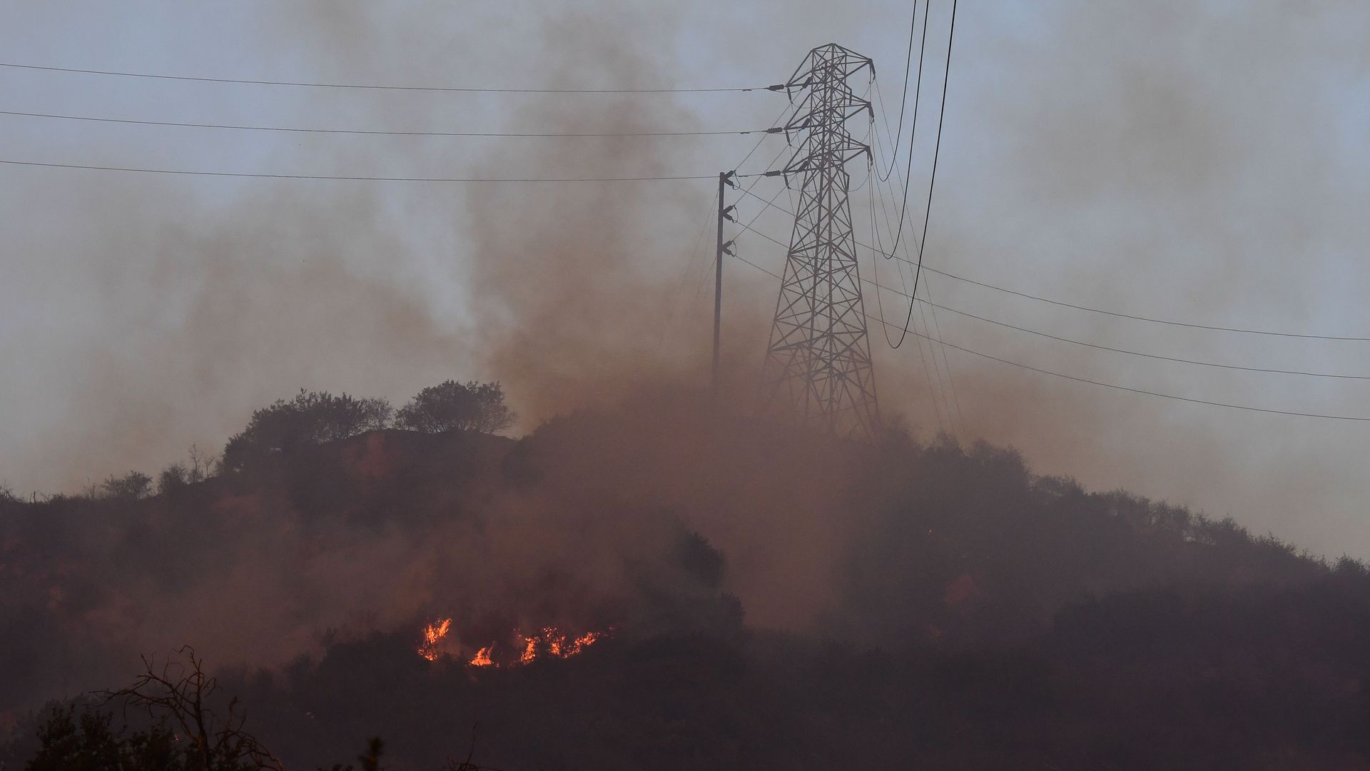 Fire burns near power lines at the Thomas Fire, December 16, 2017 in Montecito, California.