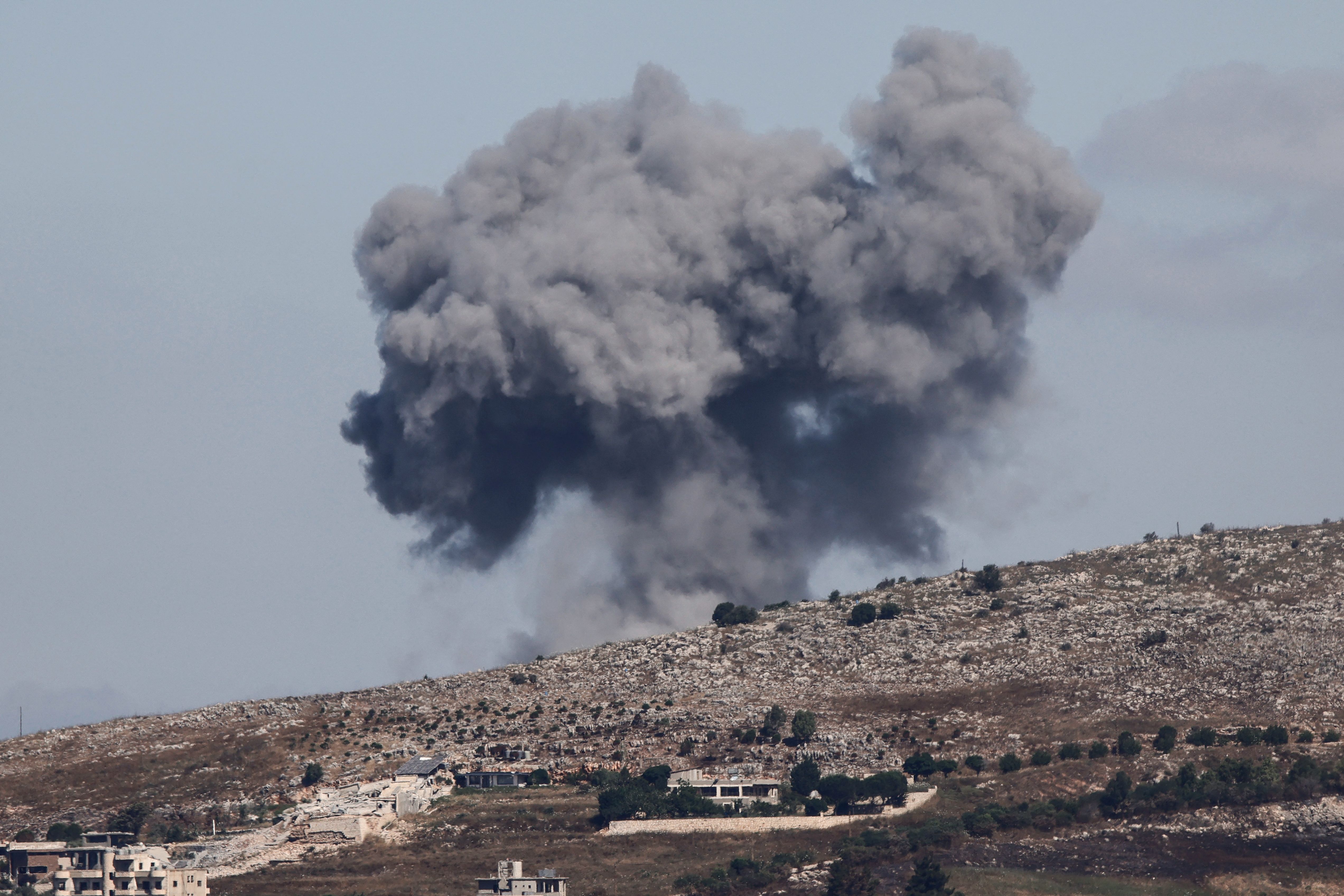 A dark cloud rises above a hill in southern Lebanon after a military strike.