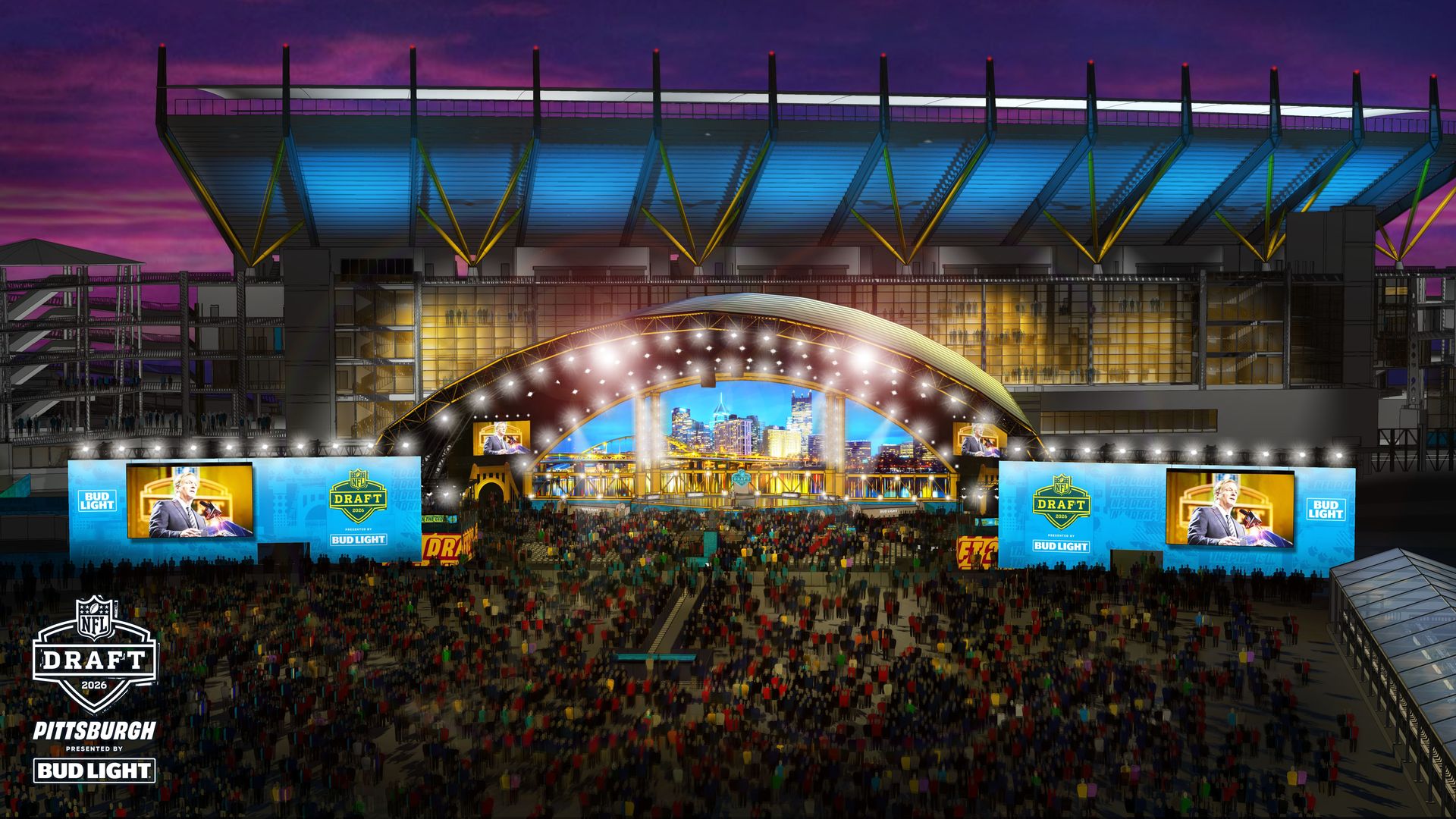 Large outdoor stadium with a stage lit by bright lights for the 2026 NFL Draft in Pittsburgh, showing a crowd, blue screens, and a city backdrop at dusk.