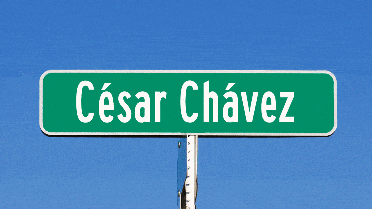 Animated illustration of a street sign that reads "César Chávez" being wiped clean. 