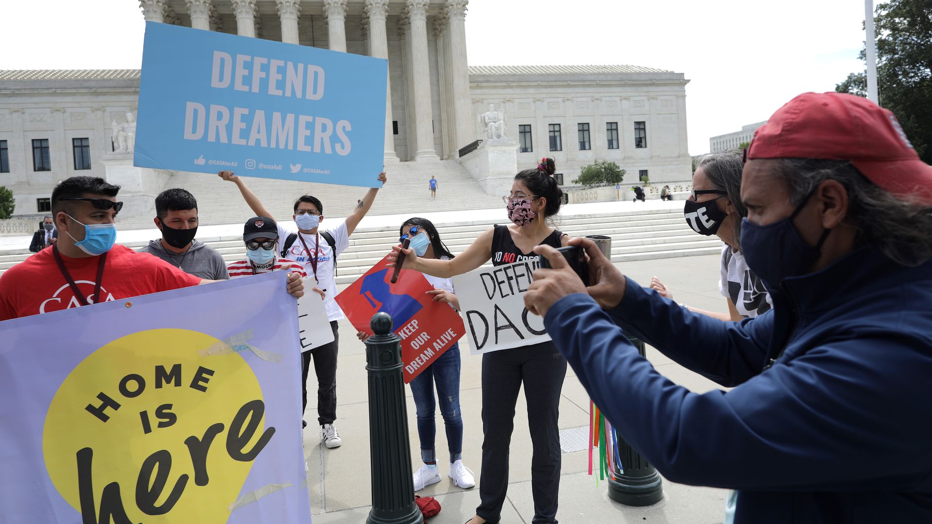 Dreamer advocates holding signs outside the Supreme Court.