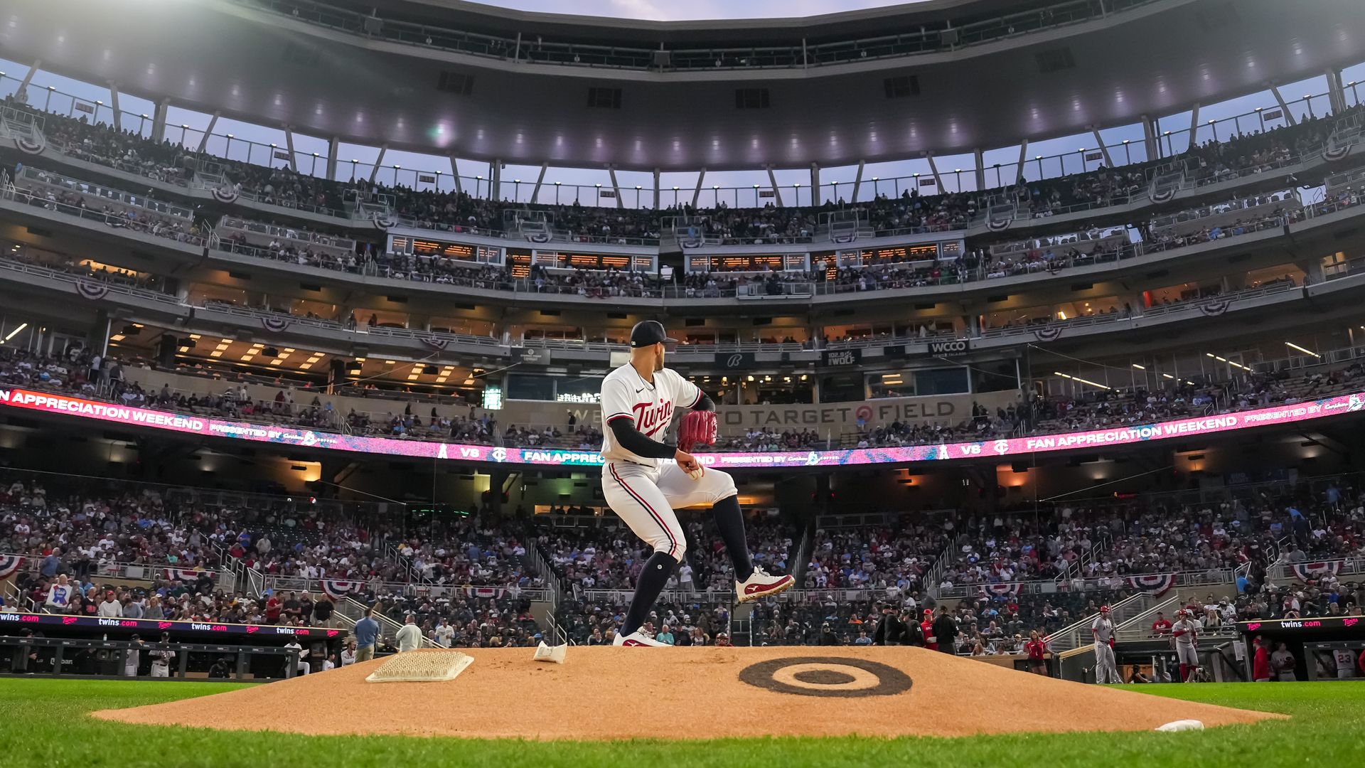 Pablo Lopez throws out a pitch at Target Field, with fans in the background 