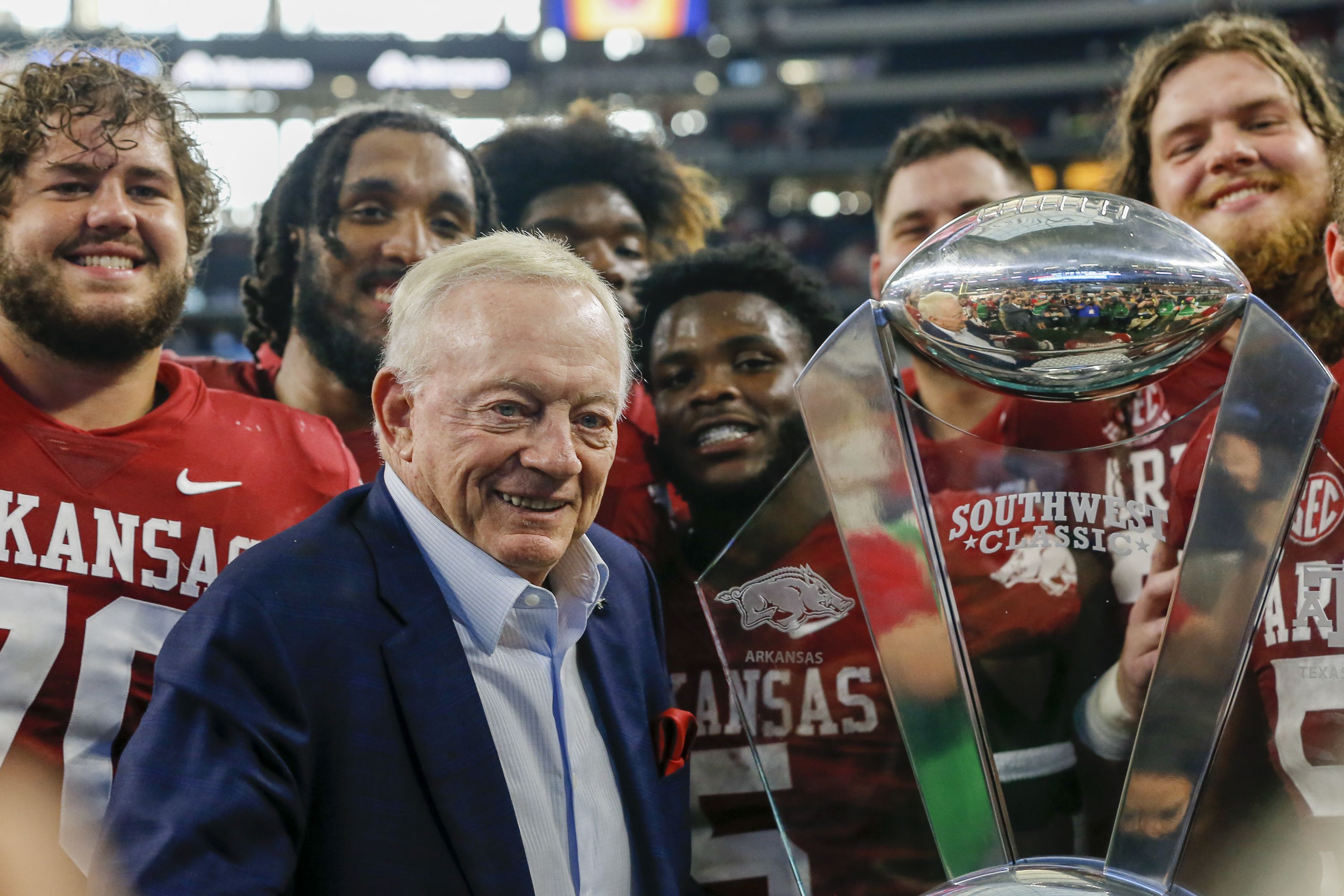 Dallas Cowboys owner Jerry Jones celebrates with the Arkansas Razorbacks players after winning Southwest Classic game between the Texas A&M Aggies.