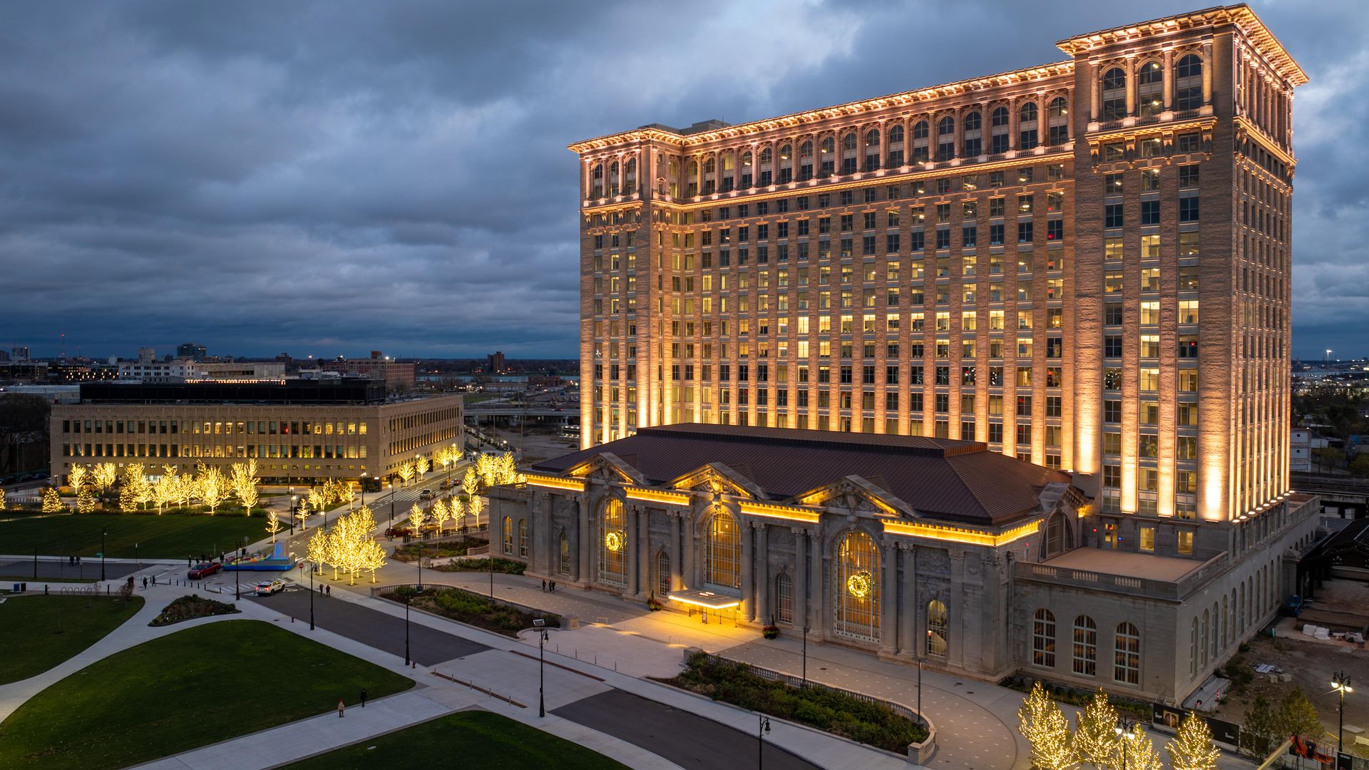 Michigan central with holiday lights on the trees around it