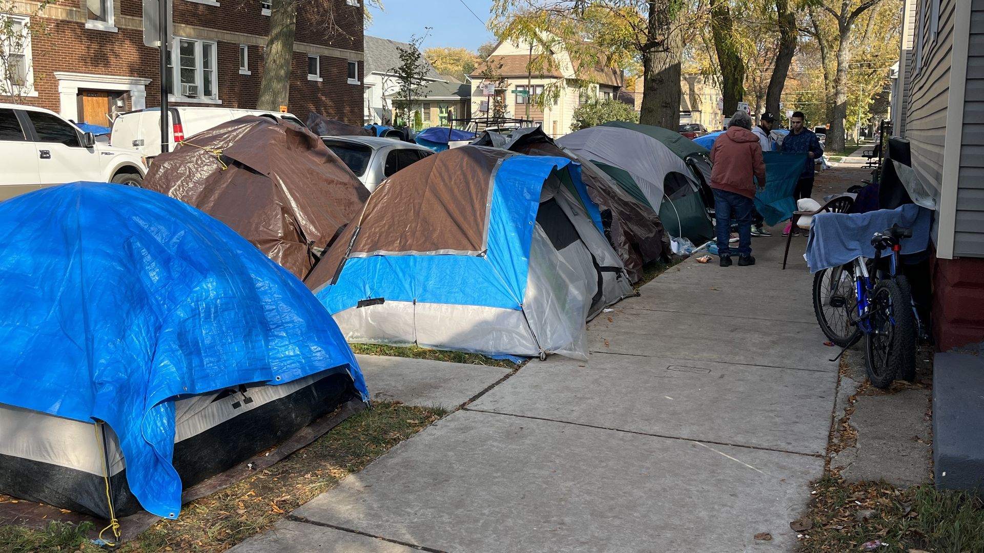 Photo of a row of tents set up on a city street 
