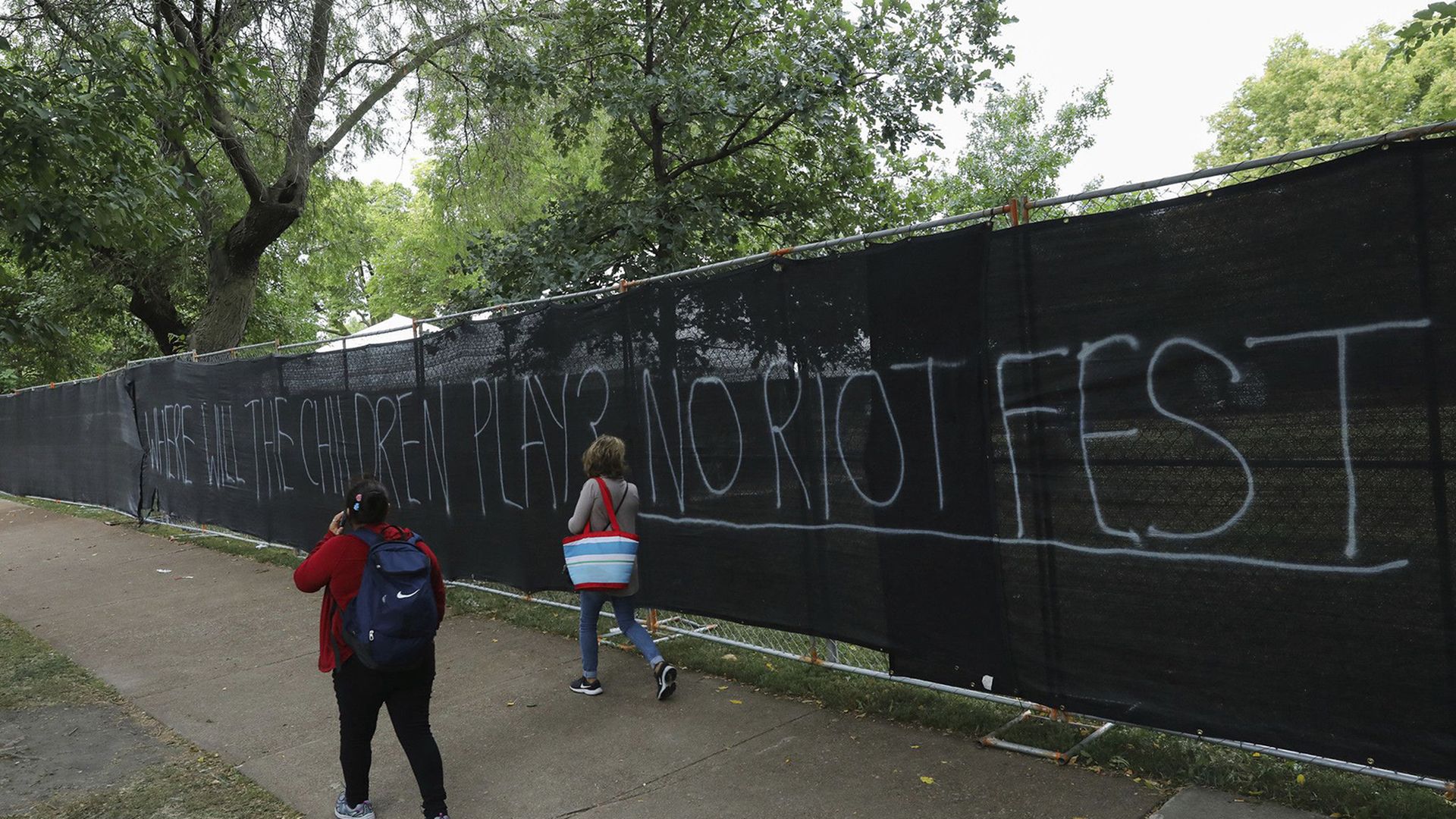 A gate of a park with No Riot Fest written on it