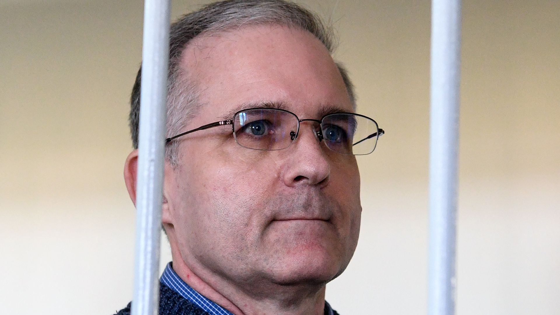Paul Whelan behind a set of bars.