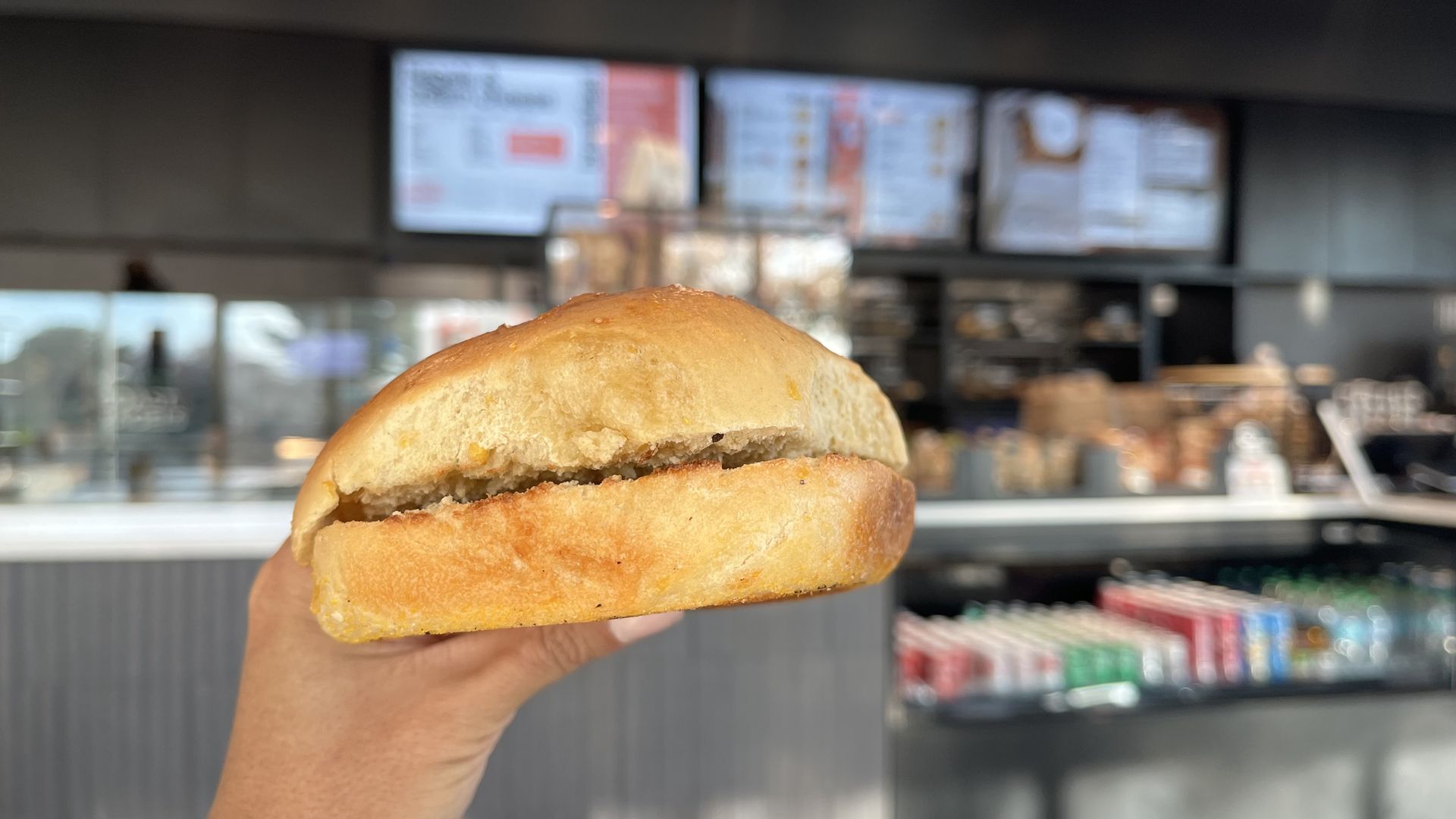 Linh holding a sweet corn bagel