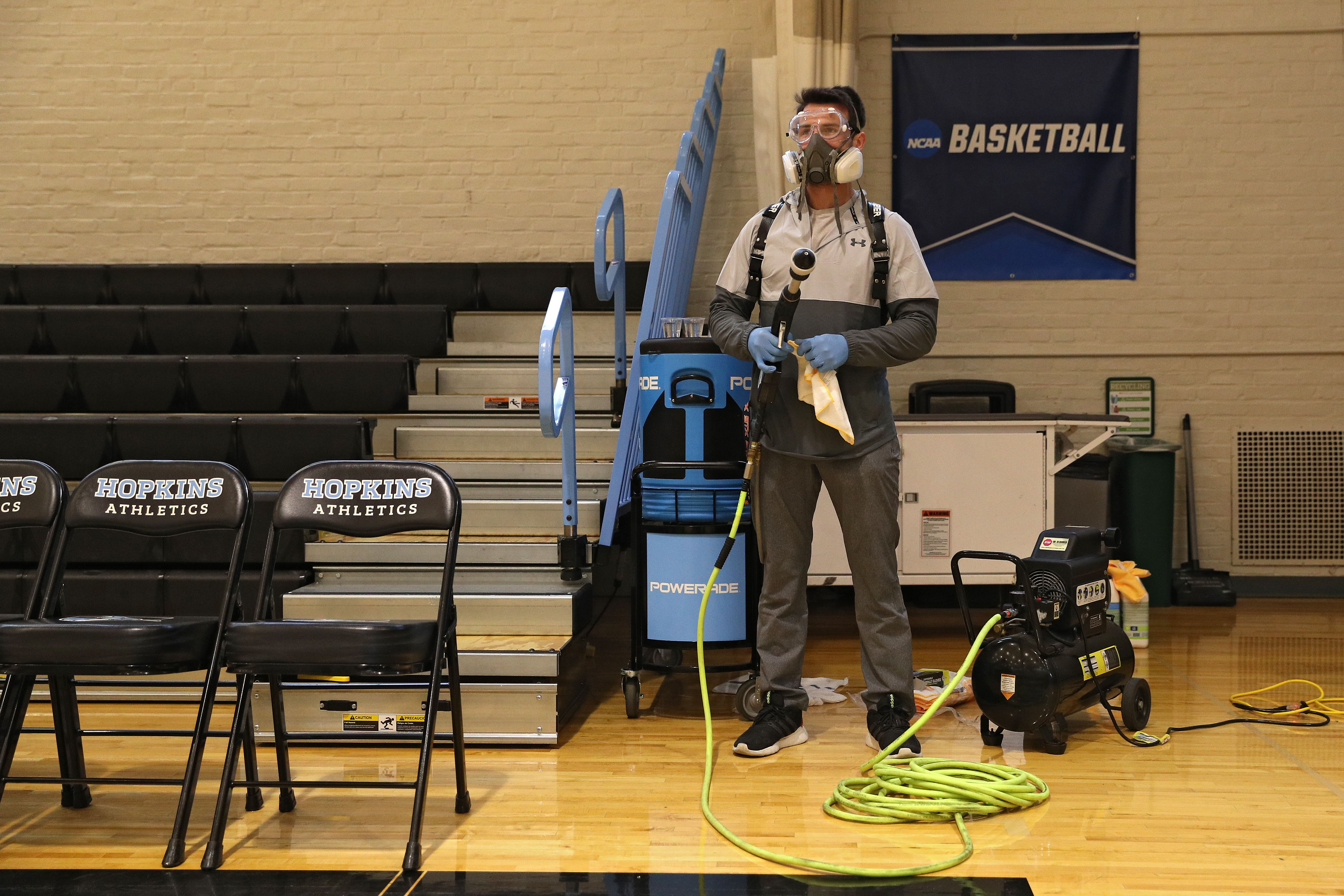 Man prepares to disinfect court
