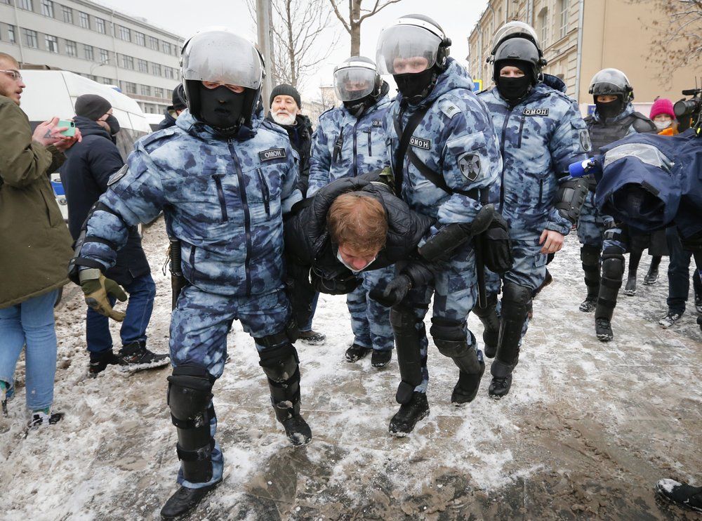Police officers detain a man during a protest on Sunday, Jan. 31, 2021. (AP Photo/Alexander Zemlianichenko)