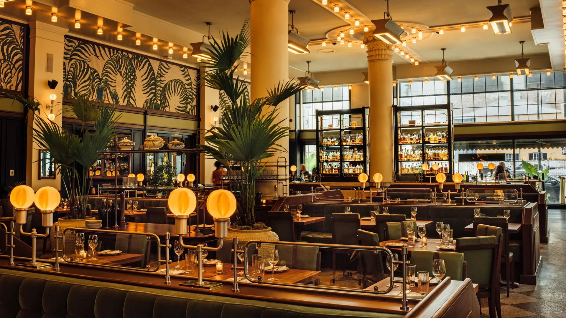 The view across empty tables in an Art Deco-inspired restaurant.