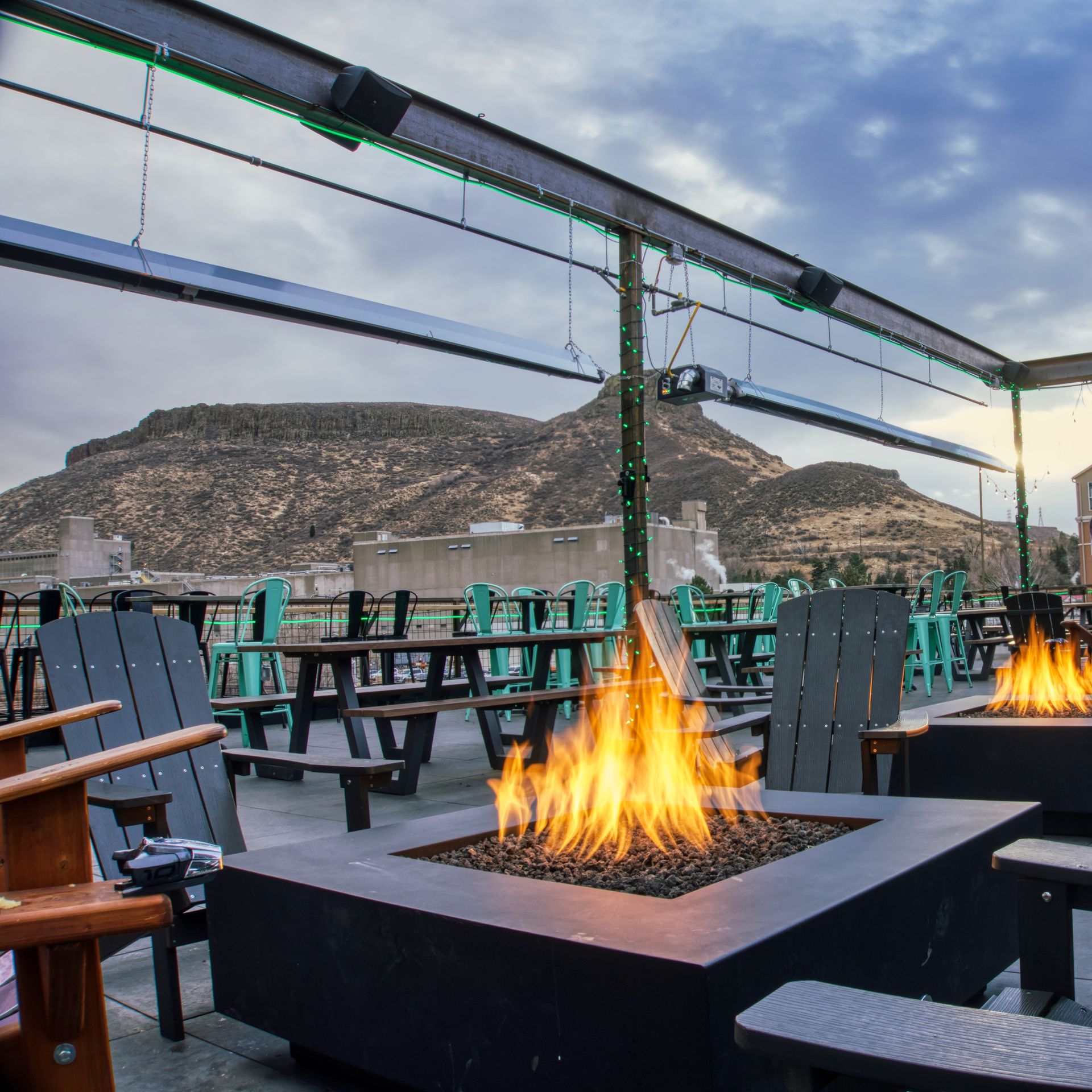 Firepits on a rooftop in front of the mountains