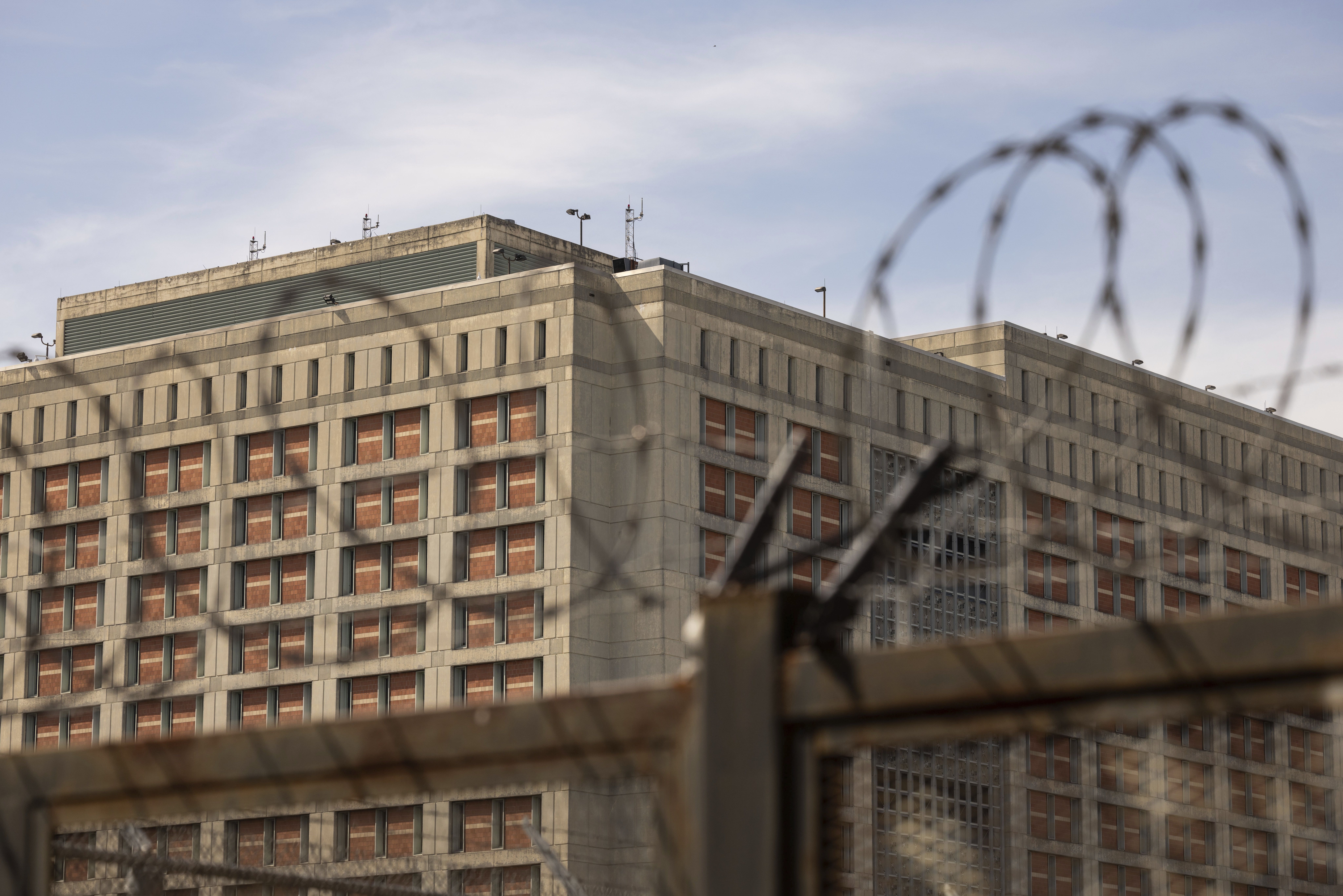 The Metropolitan Detention Center is seen through barb wire in the Sunset Park neighborhood of Brooklyn