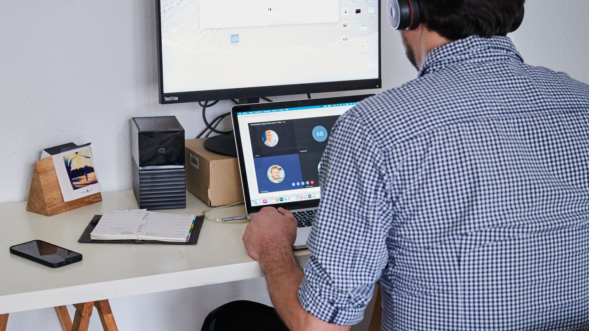  A man attends an online meeting