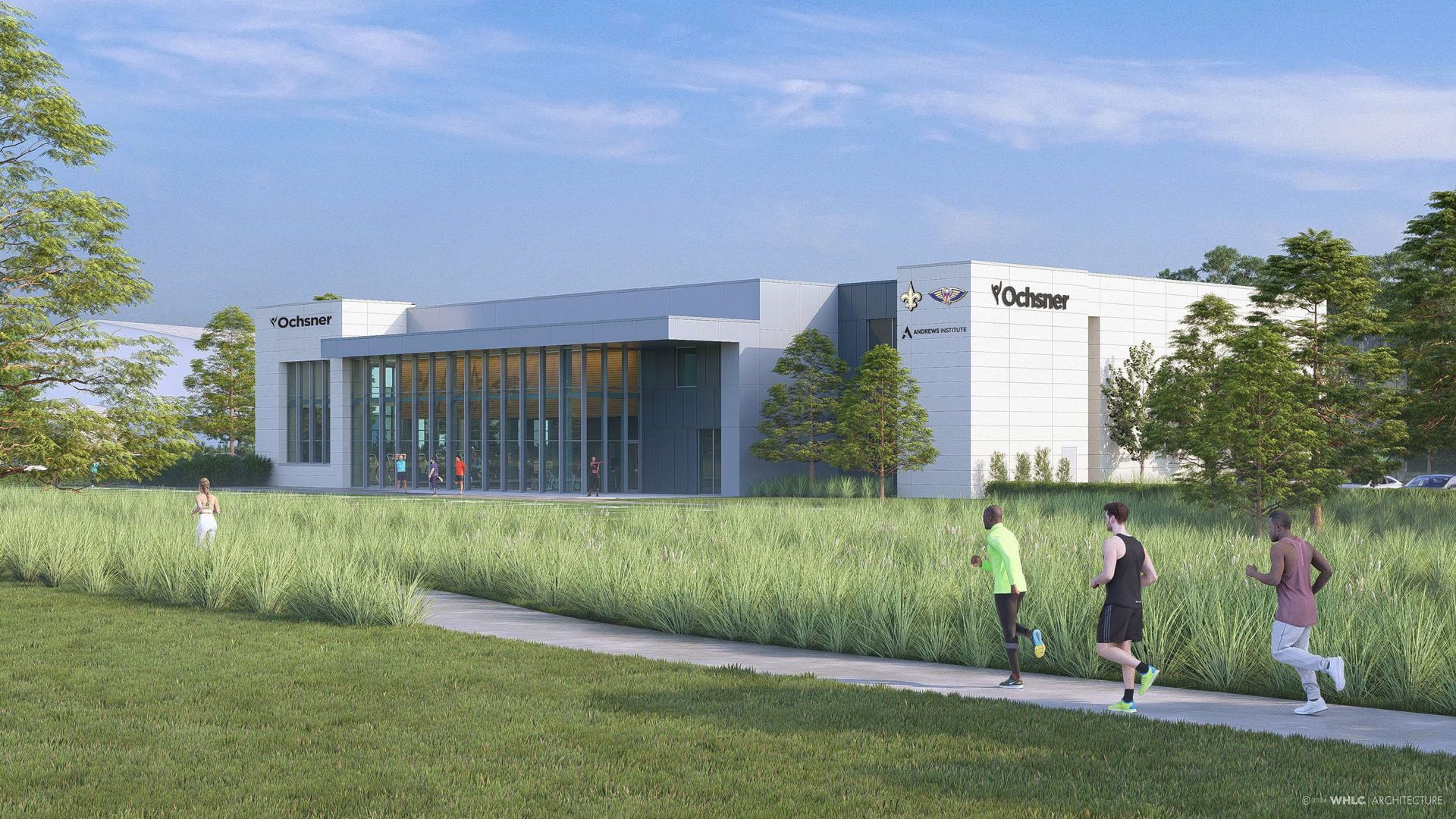 Modern white building with large windows labeled "Ochsner" and "Andrews Institute" surrounded by green grass and trees, with people jogging on a path in the foreground.