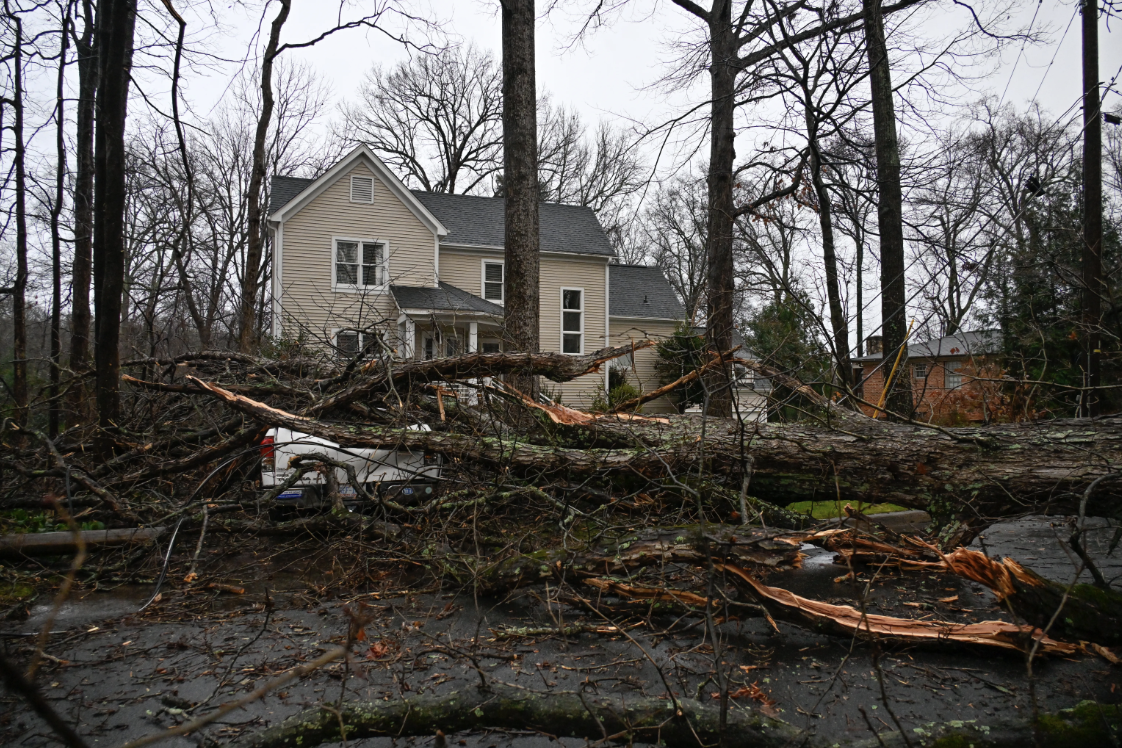 A view of a damaged car and downed trees in Charlotte due to strong winds as strong storms move through the U.S. South and the Carolinas, producing flooding, powerful winds and tornadoes on Jan. 9.