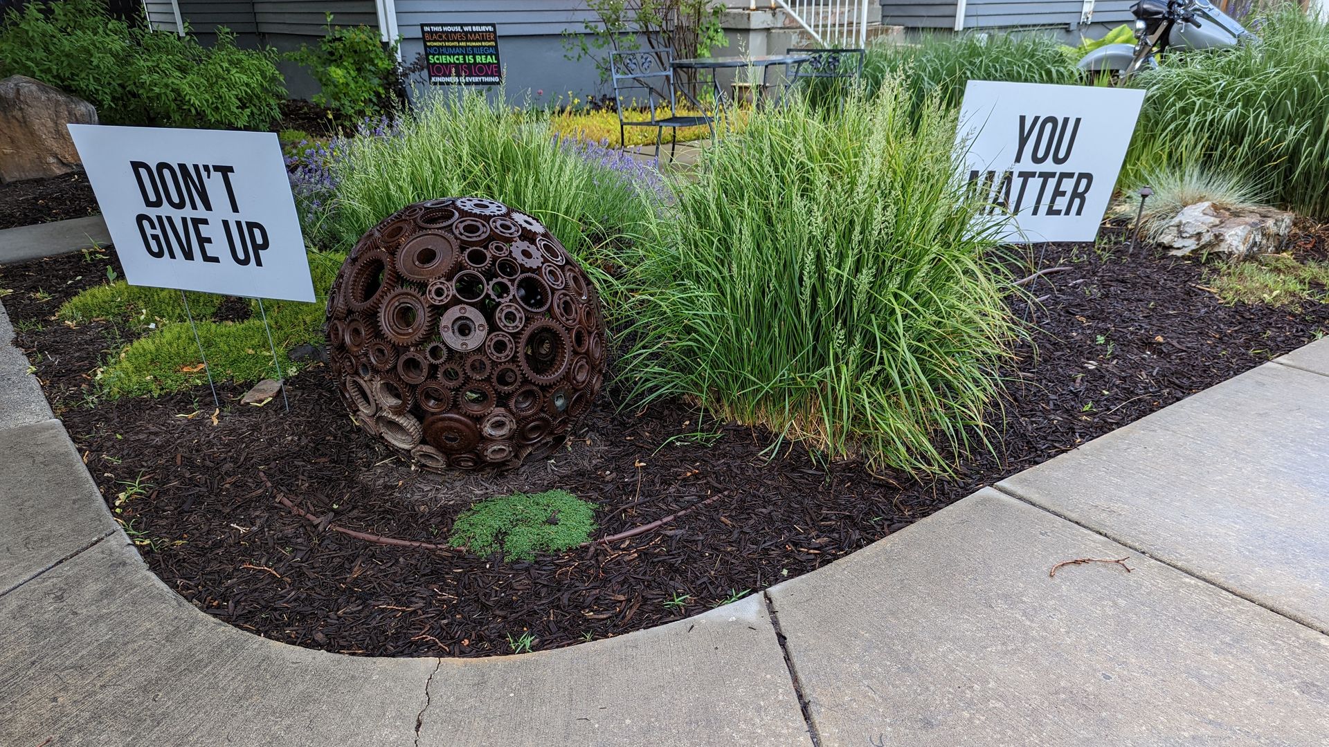 Signs in a garden state "Don't give up" and "You matter."